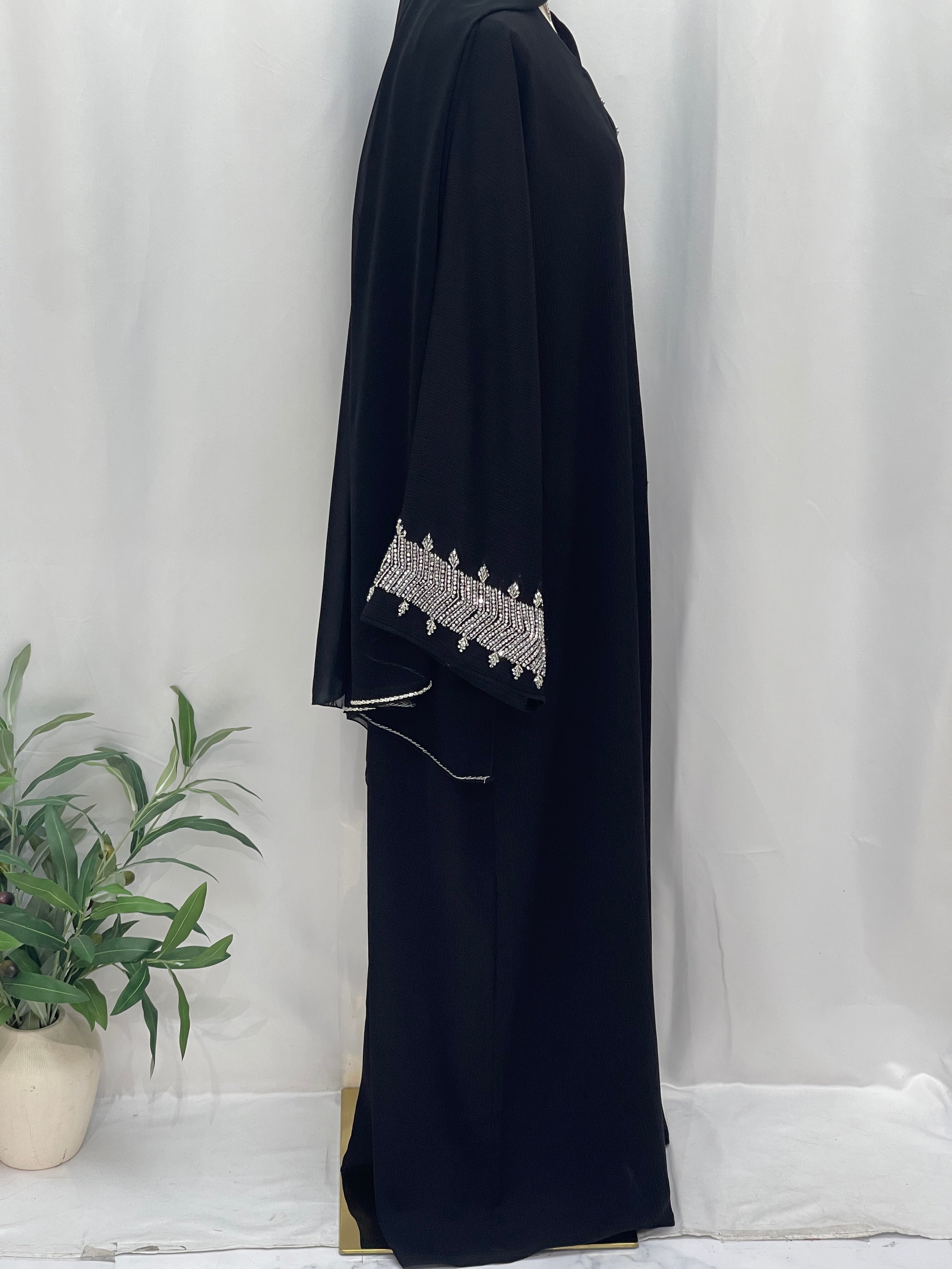 Palestinian Luxury Modest Fashion Abaya in black with intricate white embroidery on sleeve from Palestinian Elegance