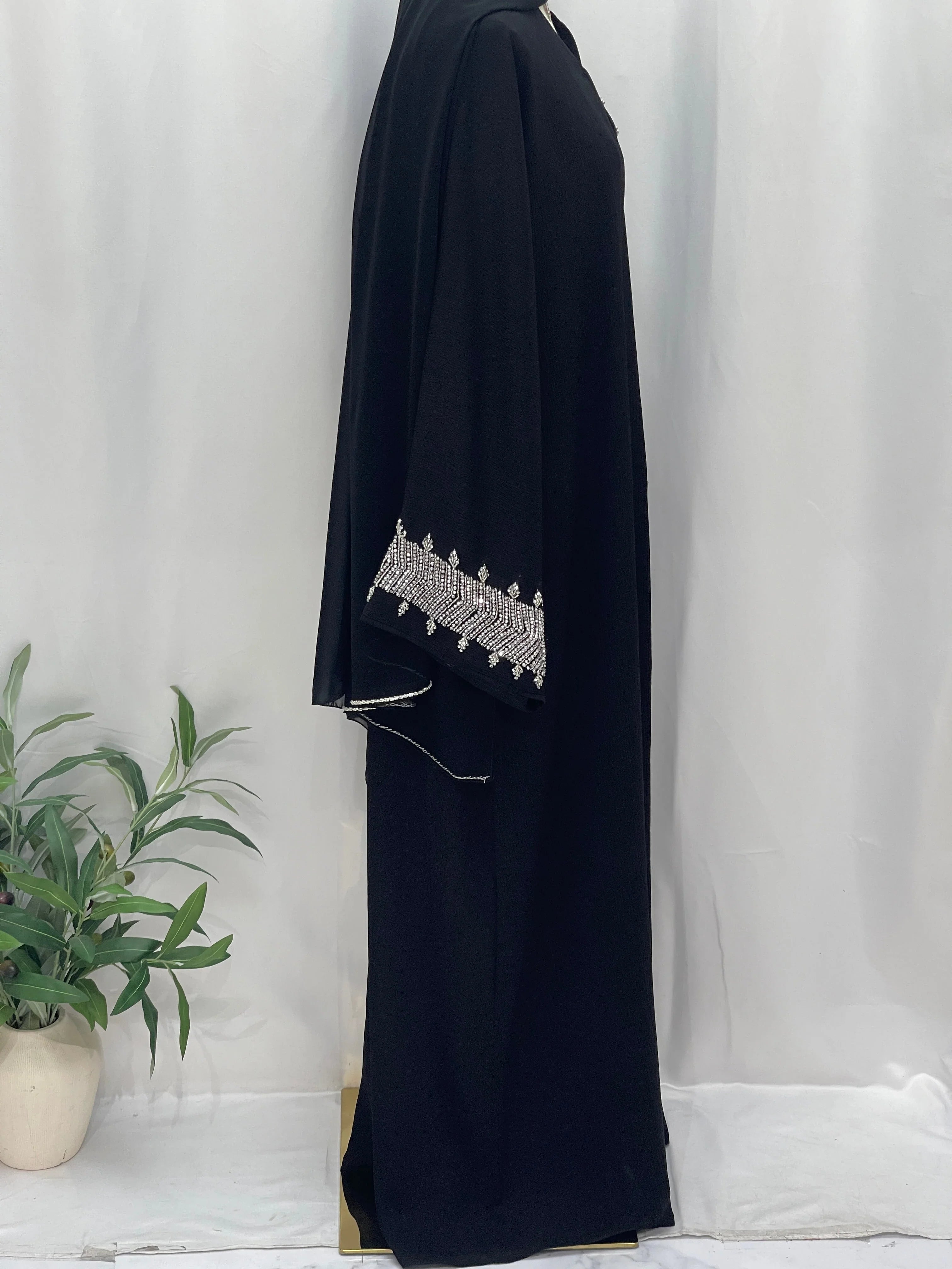 Palestinian Luxury Modest Fashion Abaya in black with intricate white embroidery on sleeve from Palestinian Elegance