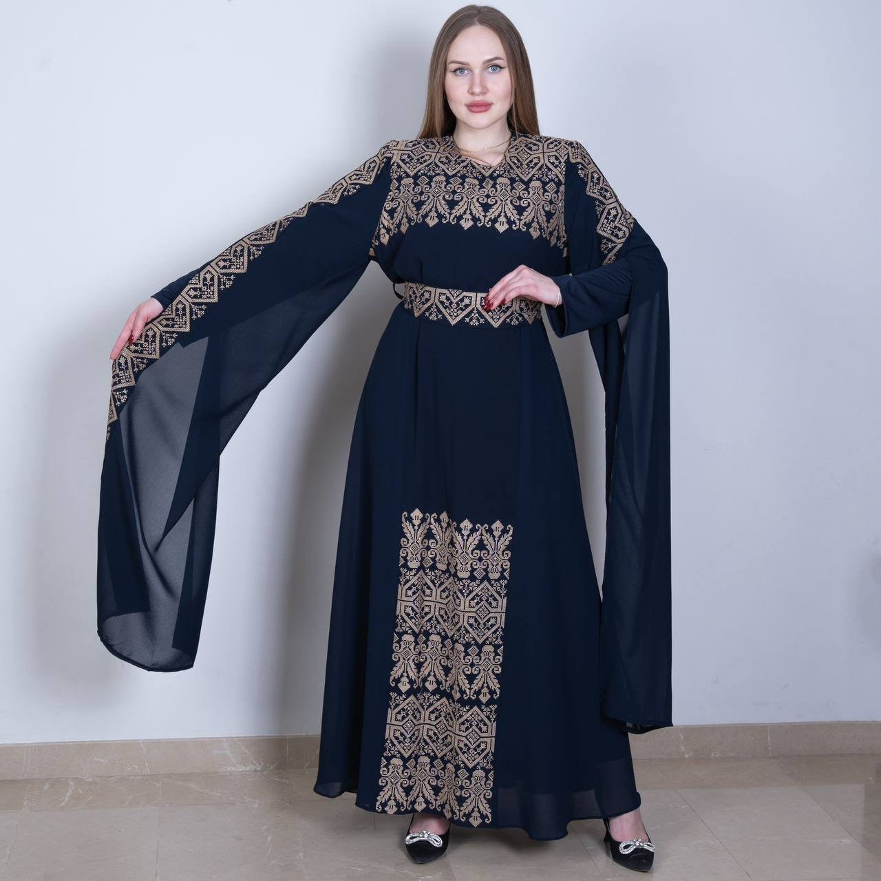 Black Palestinian embroidered dress with intricate beige embroidery and flowing sheer sleeves by Palestinian Elegance