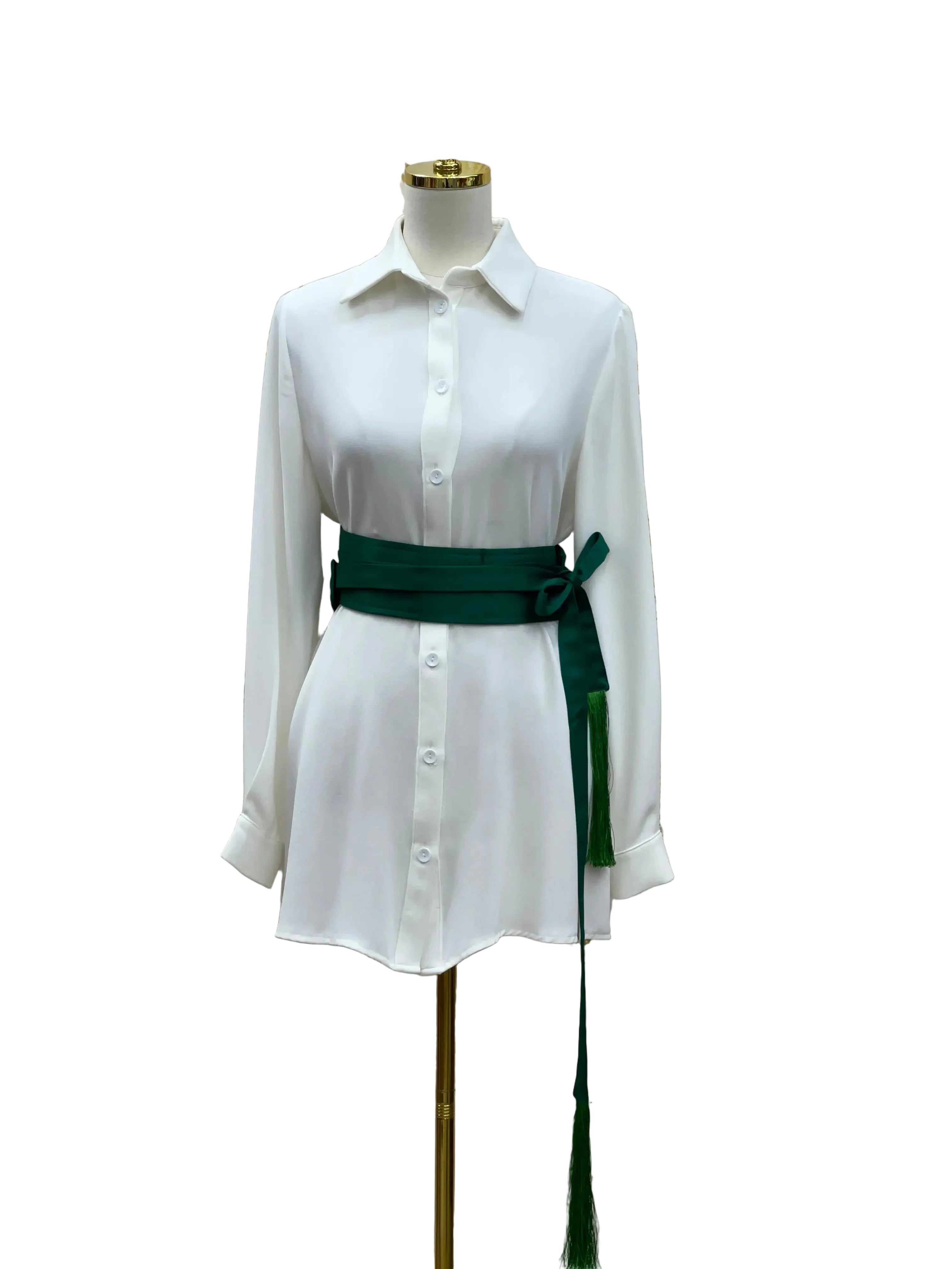Luxury satin belt for dresses in dark green wrapped around white button-down dress on mannequin