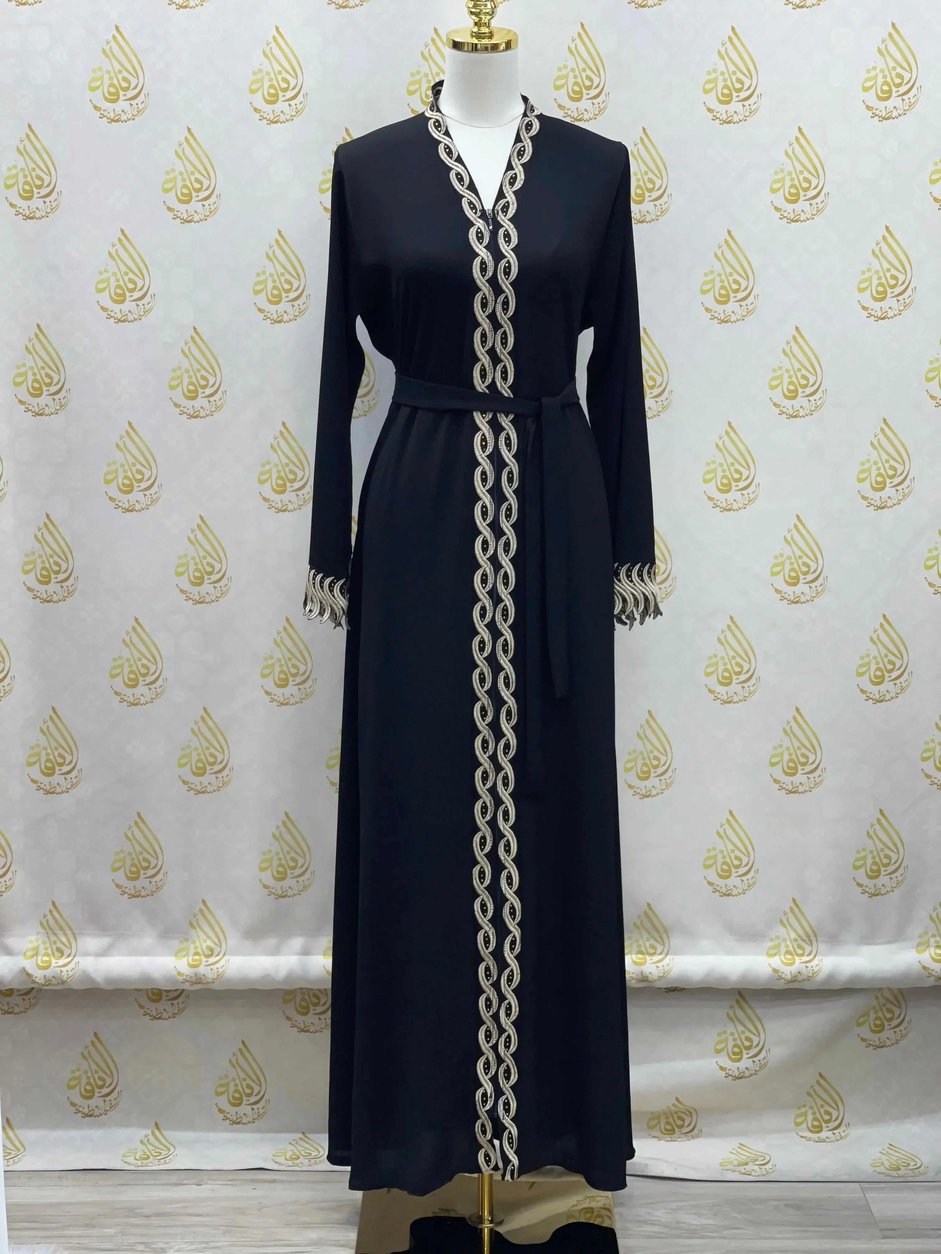 Palestinian Elegance elegant embroidered abaya in black with intricate gold trim and waist belt