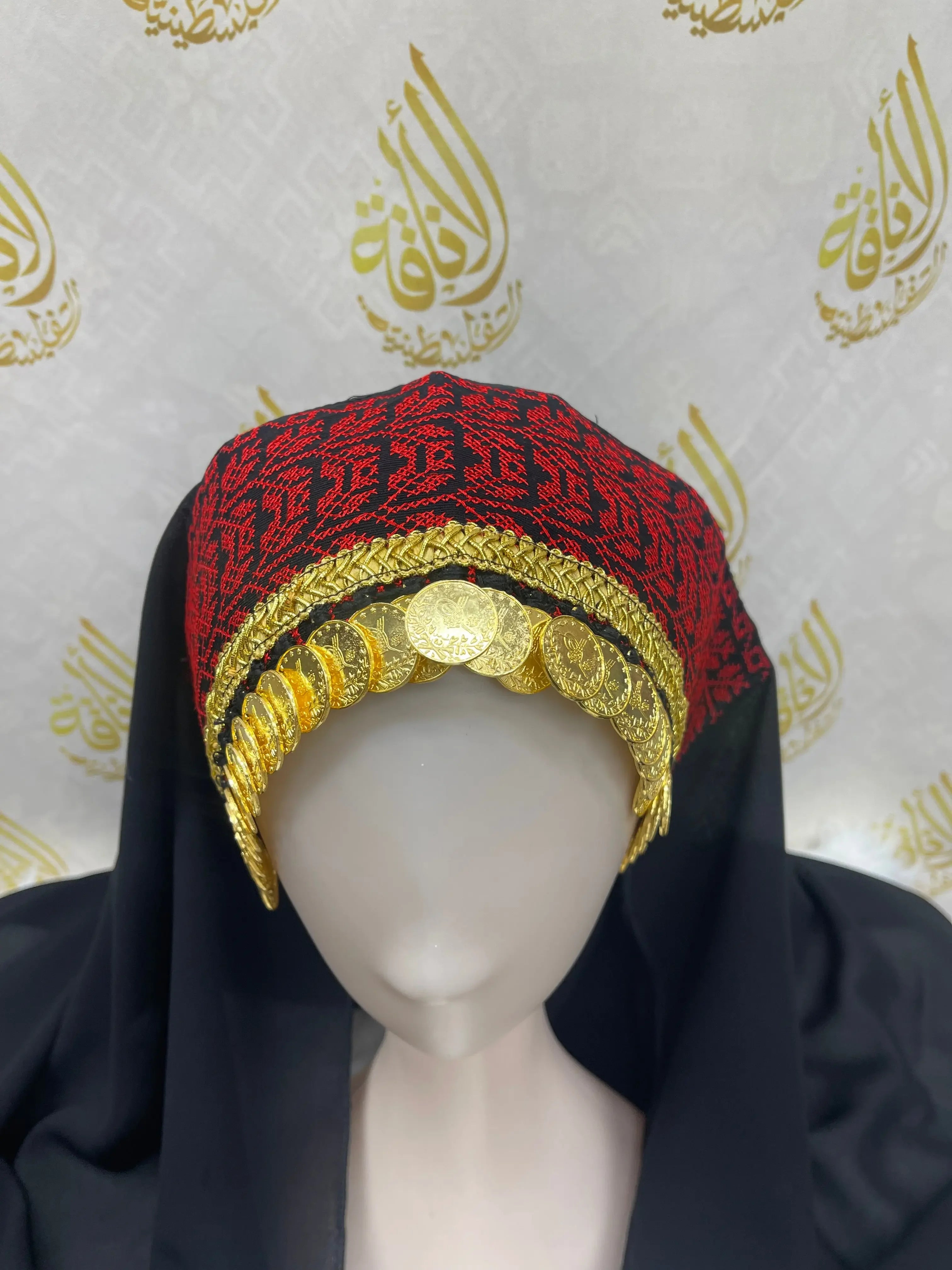 Palestinian embroidered khirka shawl with red and black embroidery and gold coin detailing from Palestinian Elegance