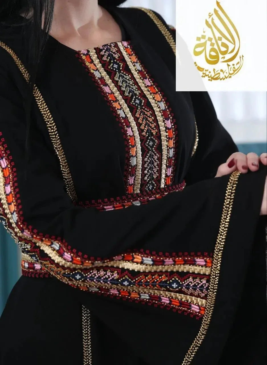 Embroidered Palestinian kaftan in black with intricate colorful traditional embroidery on sleeves and chest