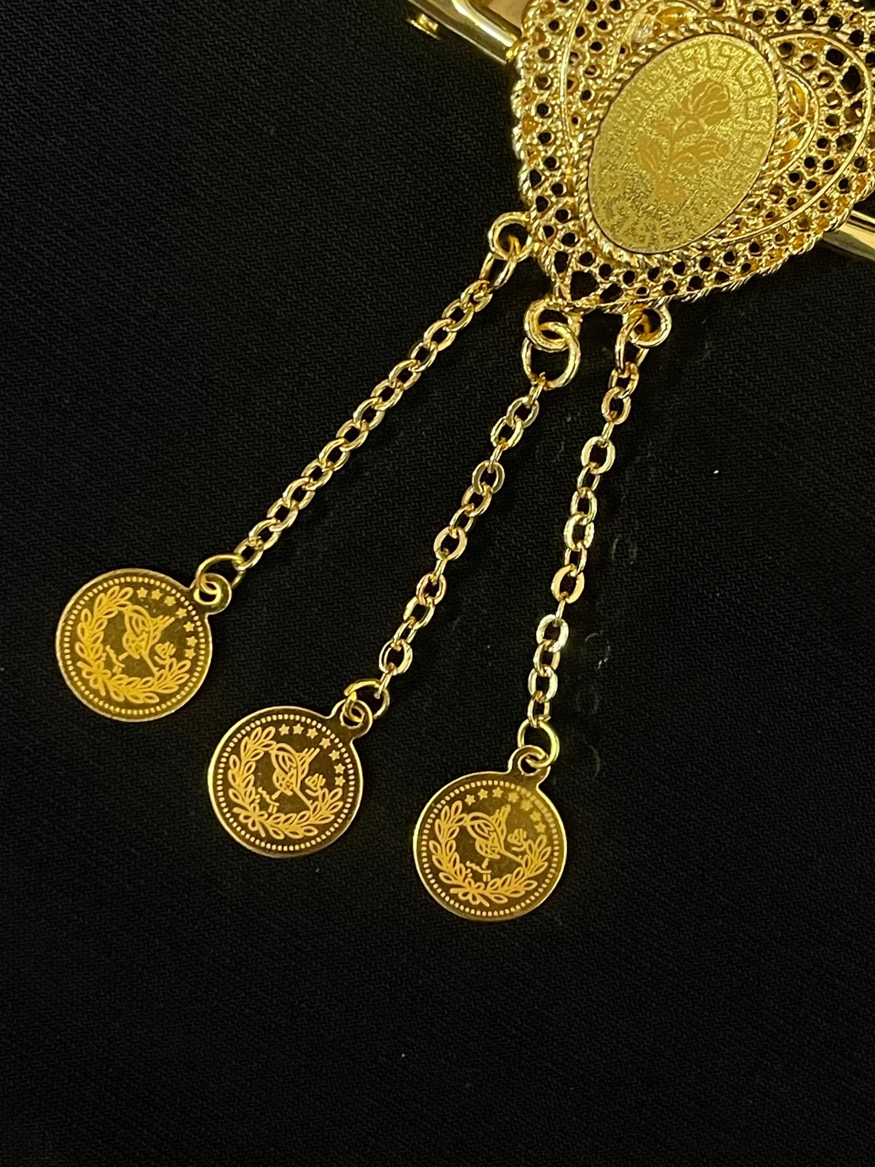 Palestinian Elegance imitated gold hair clip with intricate filigree design and hanging coin charms
