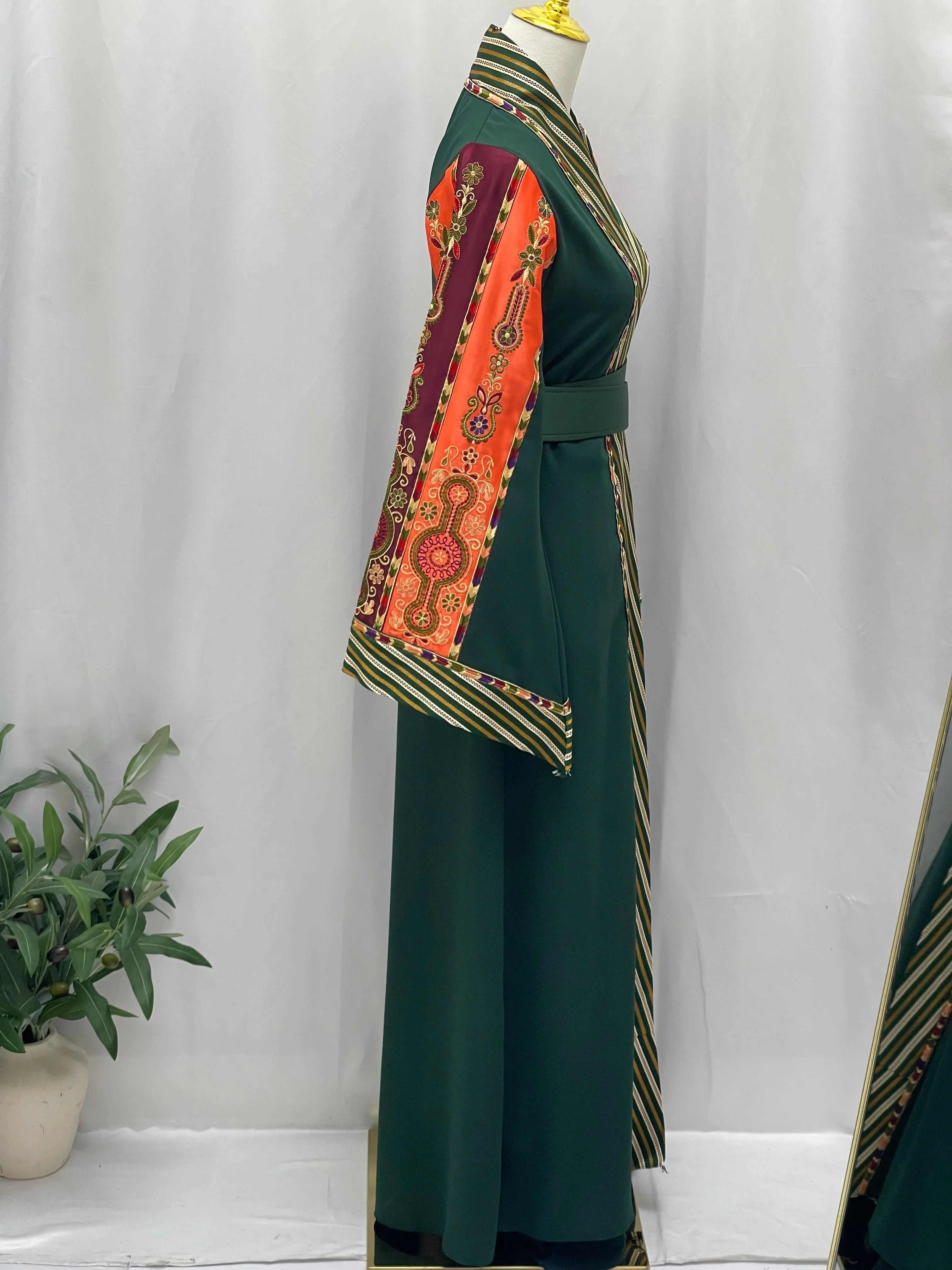 Palestinian Elegance elegant modest fashion bisht cardigan in green with vibrant patterned sleeves and belt