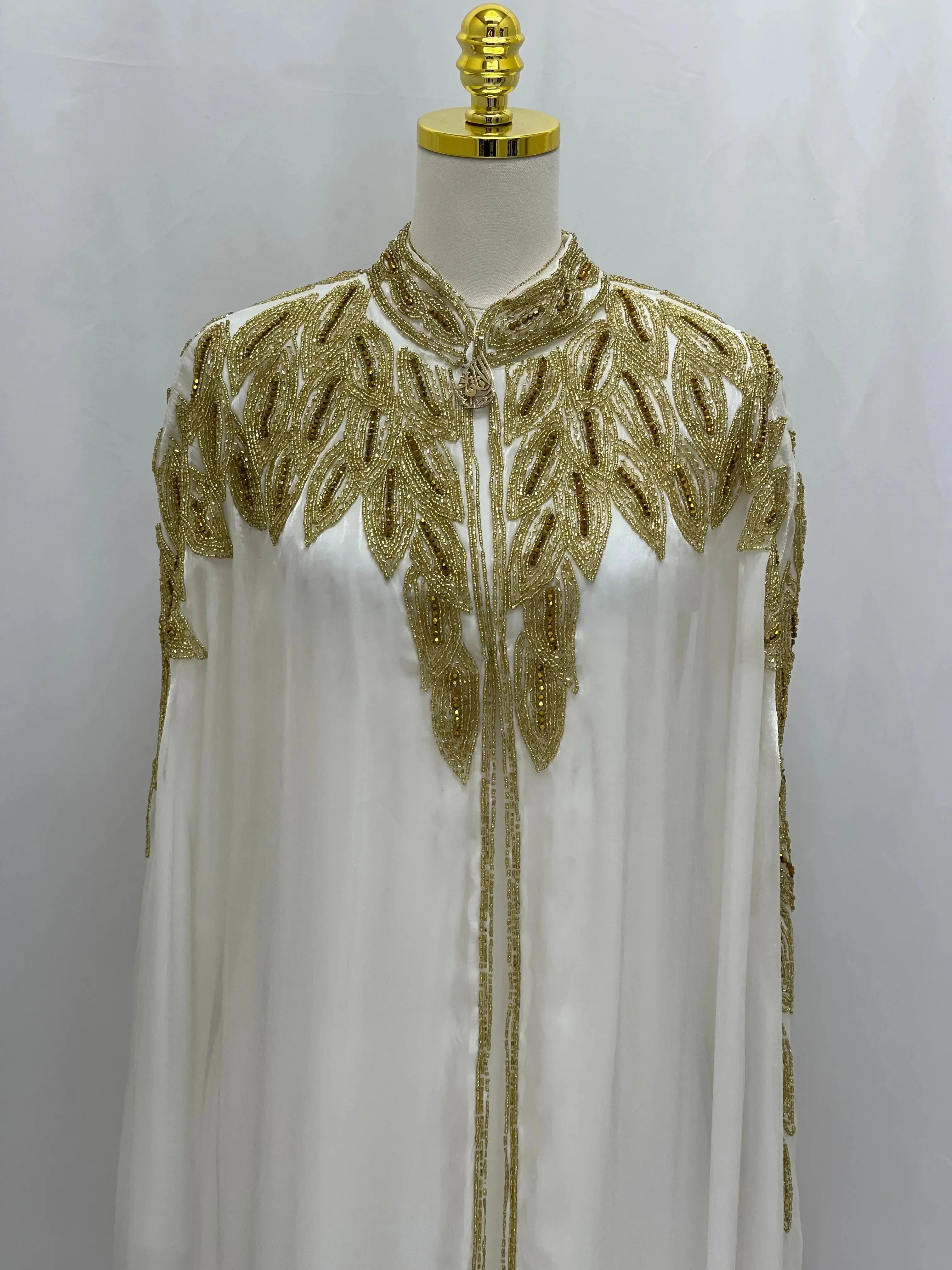 Palestinian Elegance white cardigan with gold embroidery detailing elegant modest fashion cape style