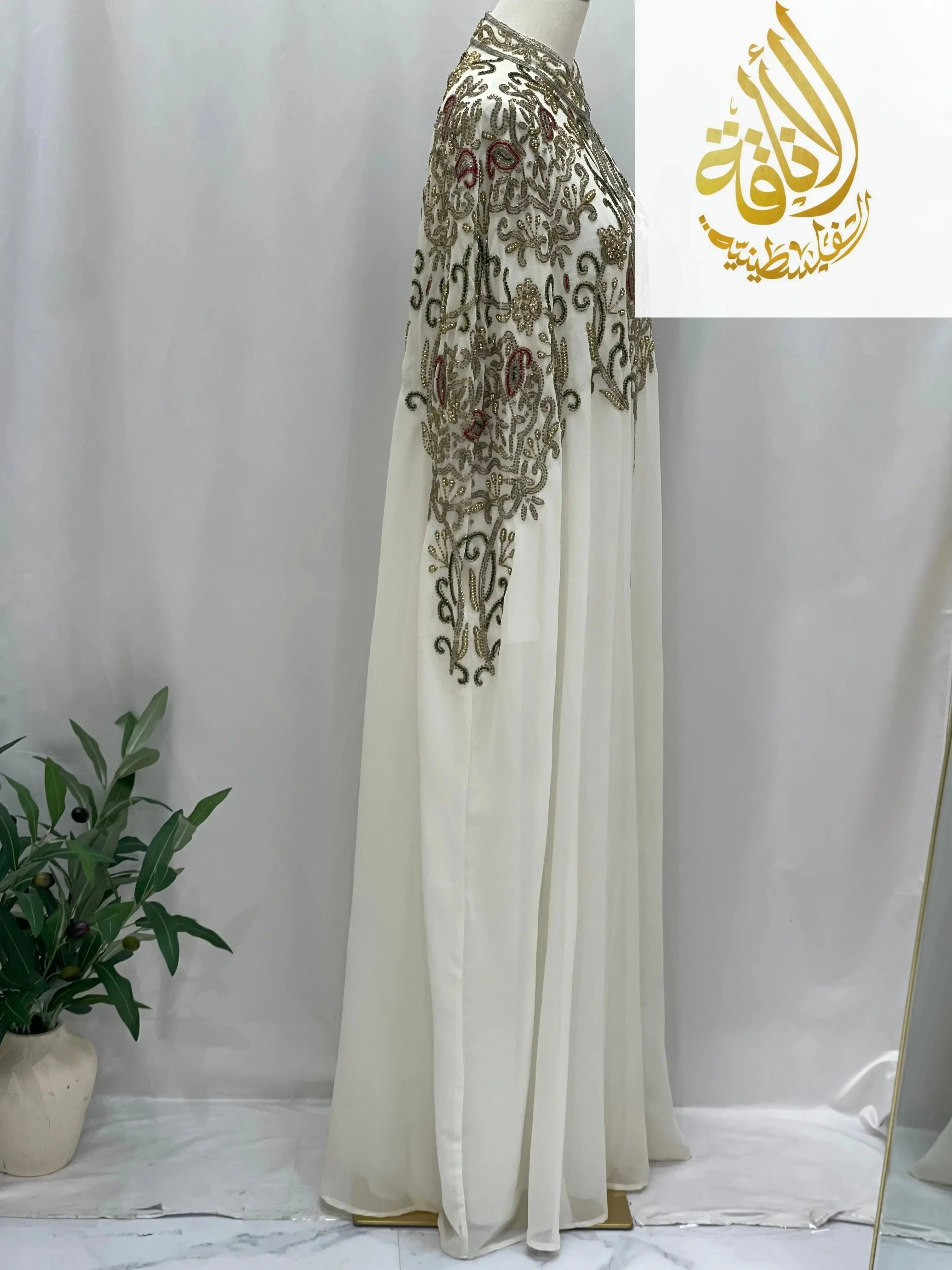 Palestinian Elegance white cardigan with intricate embroidery showcasing elegant modest fashion cape style