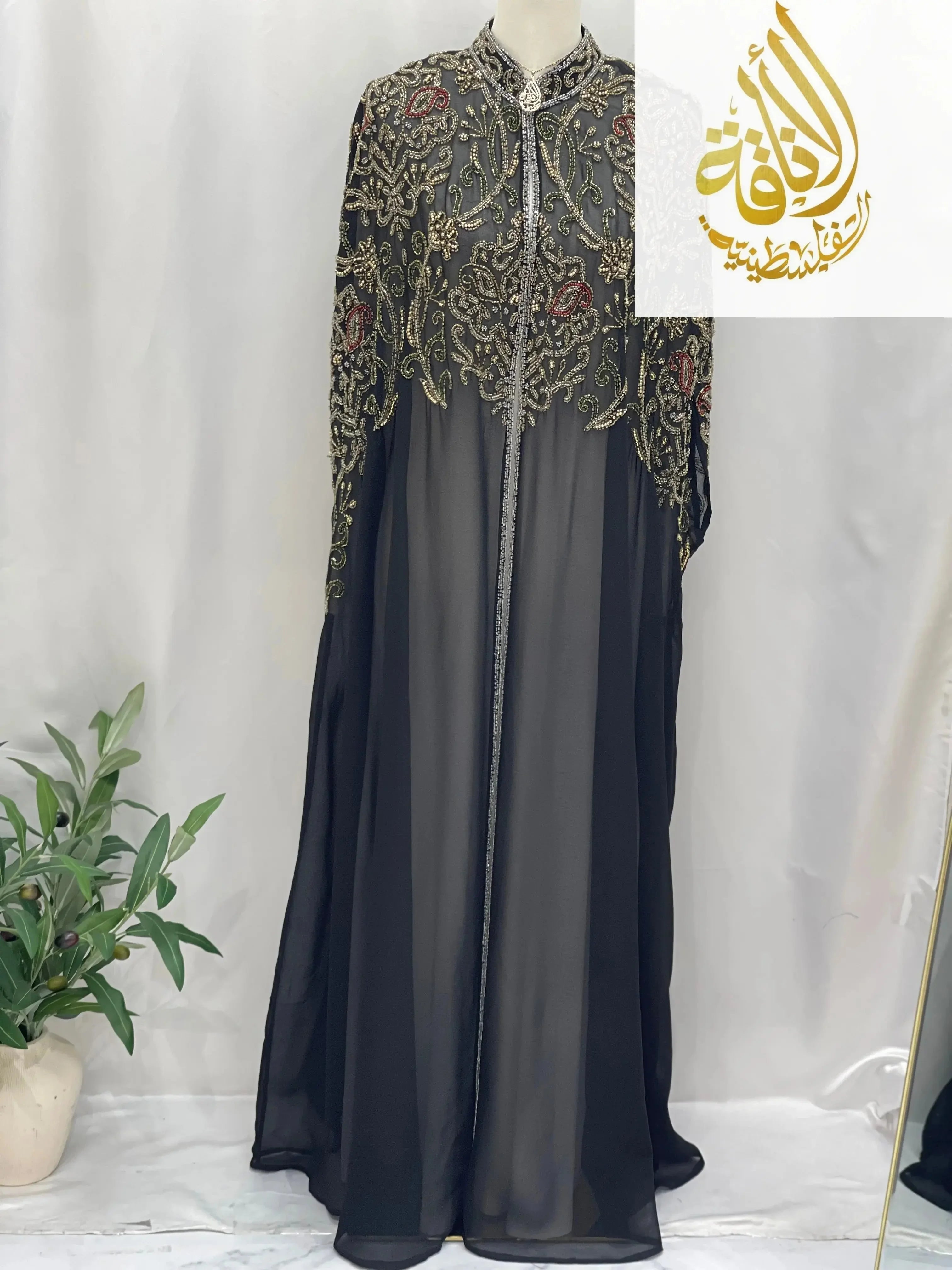 Palestinian Elegance elegant modest fashion cape in black with intricate gold embroidery and red floral accents