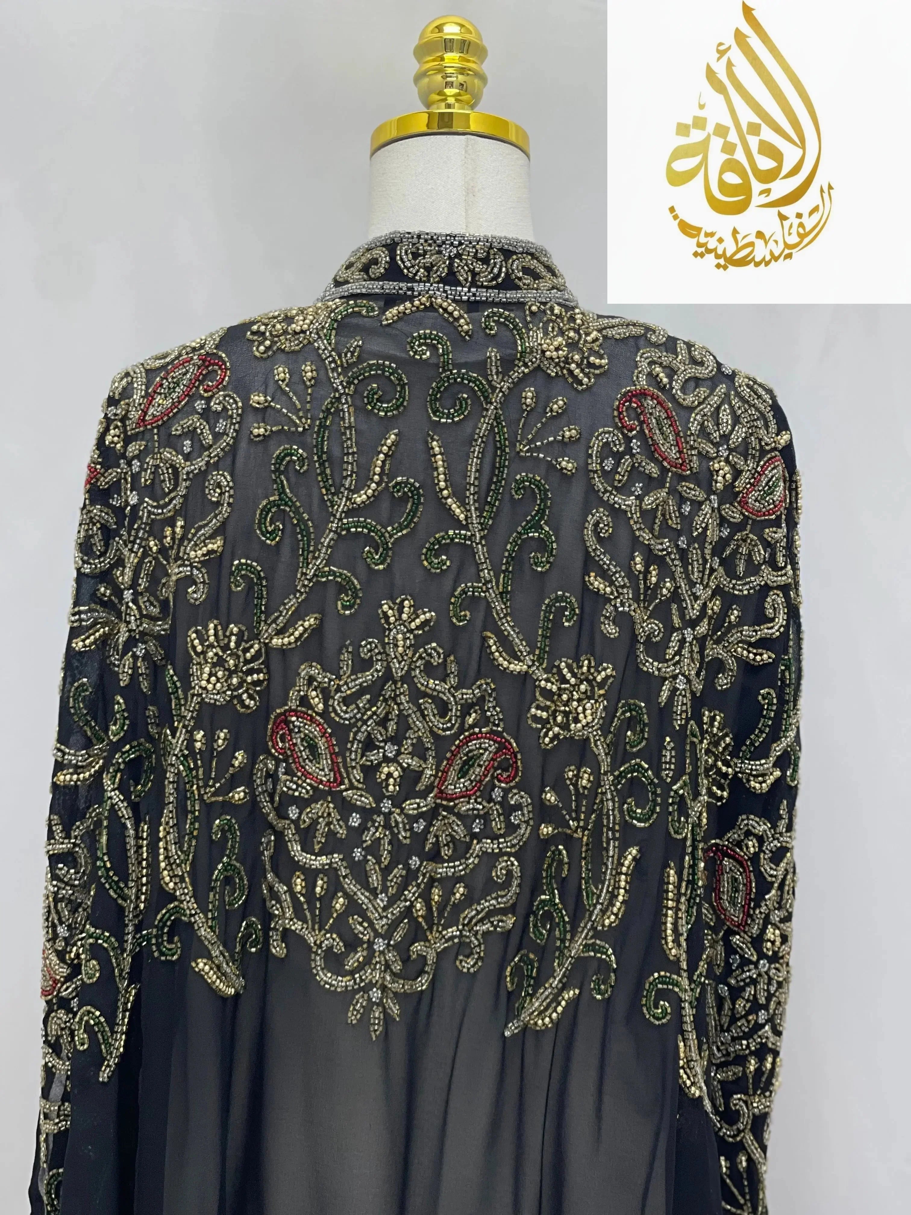 Palestinian Elegance black cardigan with intricate gold and red embroidery, elegant modest fashion cape style