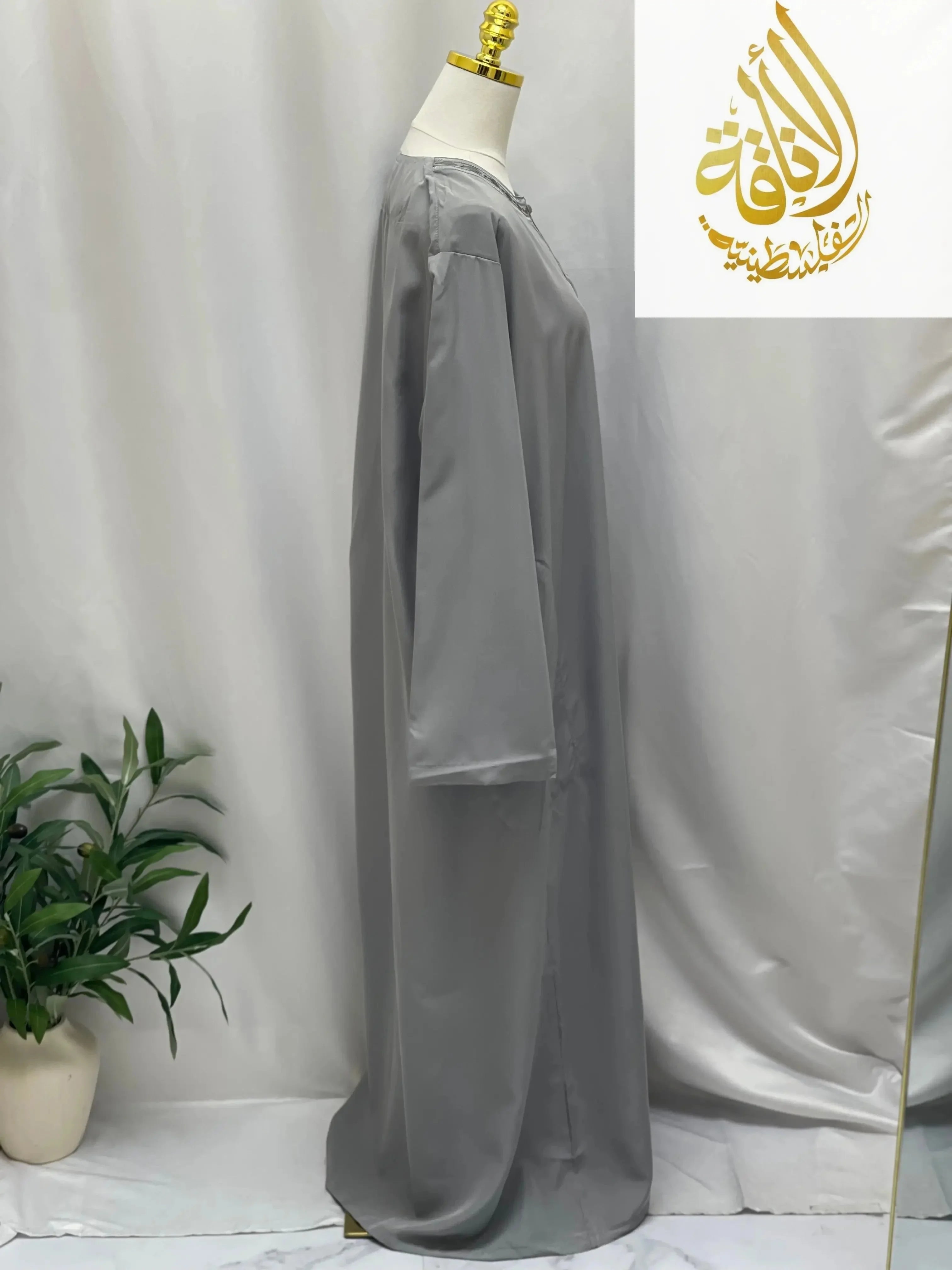 Palestinian Elegance men embroidered thobe dress in gray displayed on mannequin side view