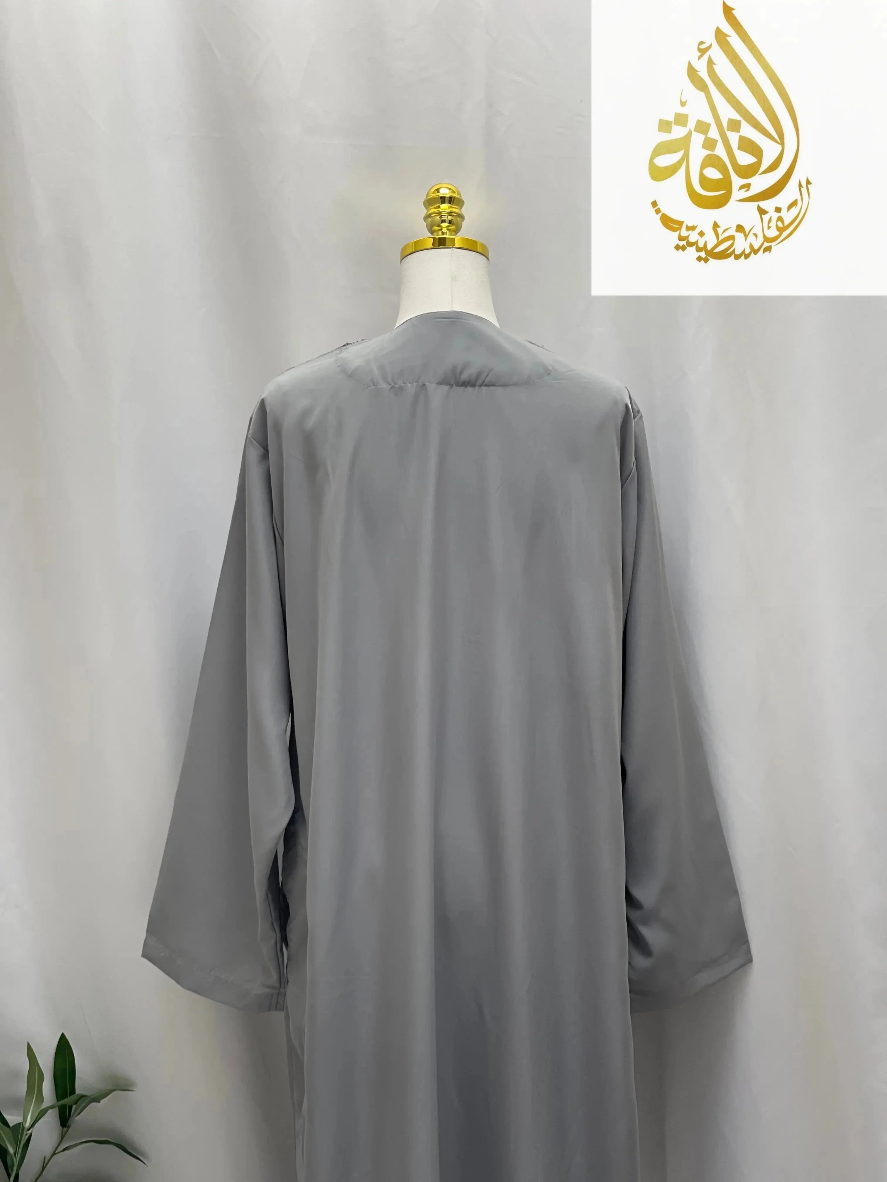 Gray embroidered thobe dress for men by Palestinian Elegance displayed on mannequin back view