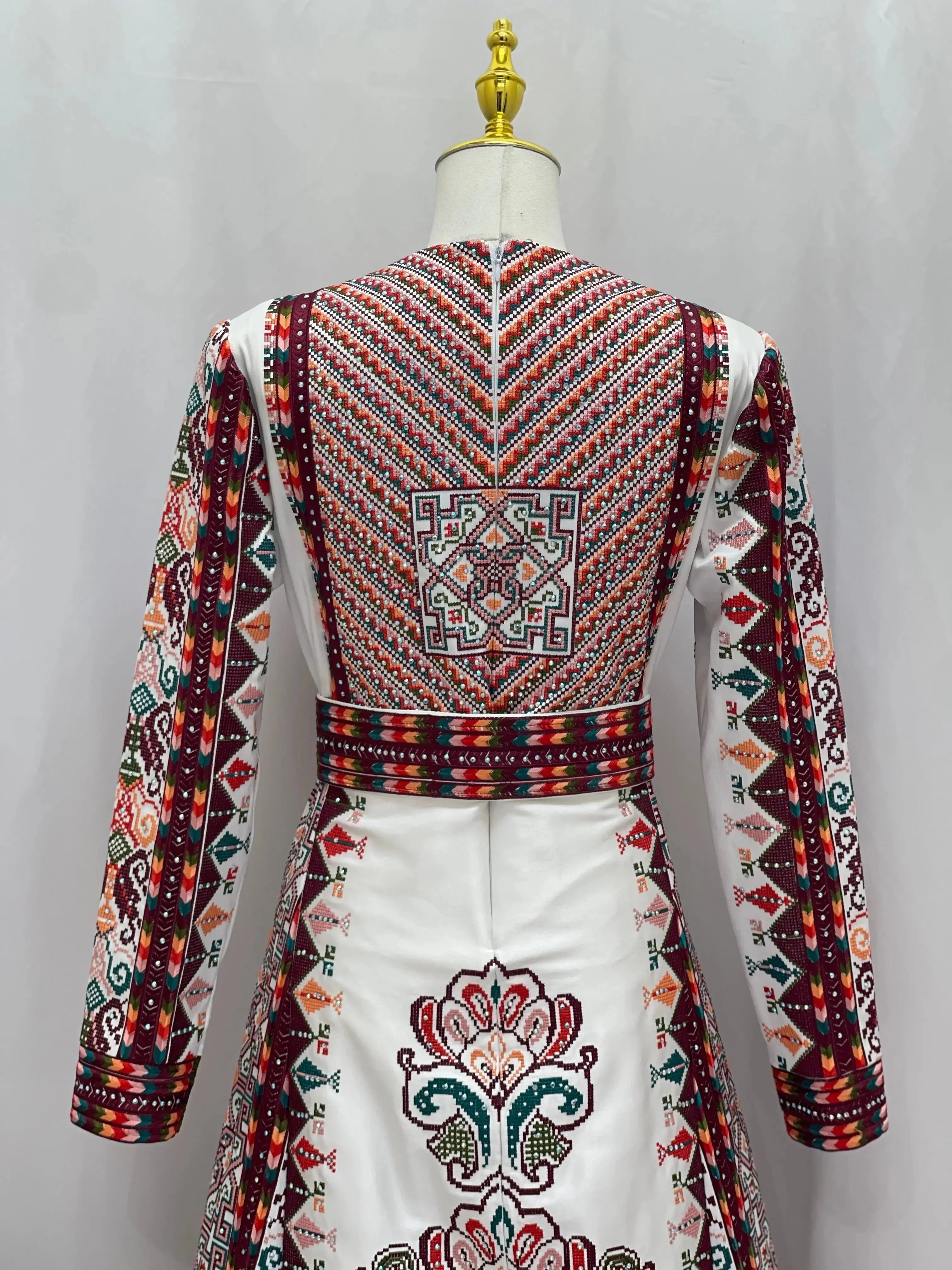 White Palestinian bridal thoub with traditional intricate embroidery on back and sleeves by Palestinian Elegance