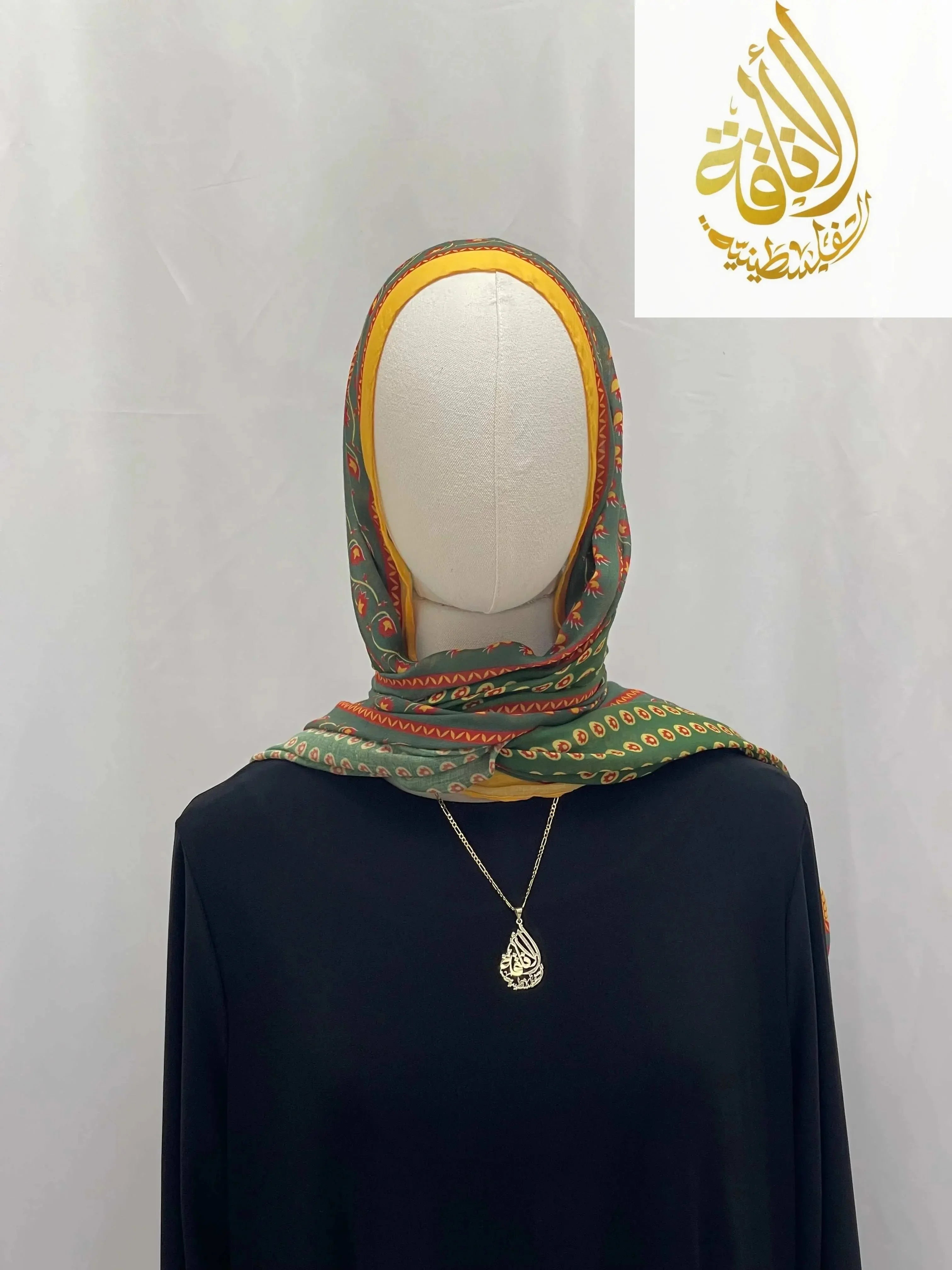 Palestinian Elegance Long Siti Asba Hijab in green with orange border and paisley design