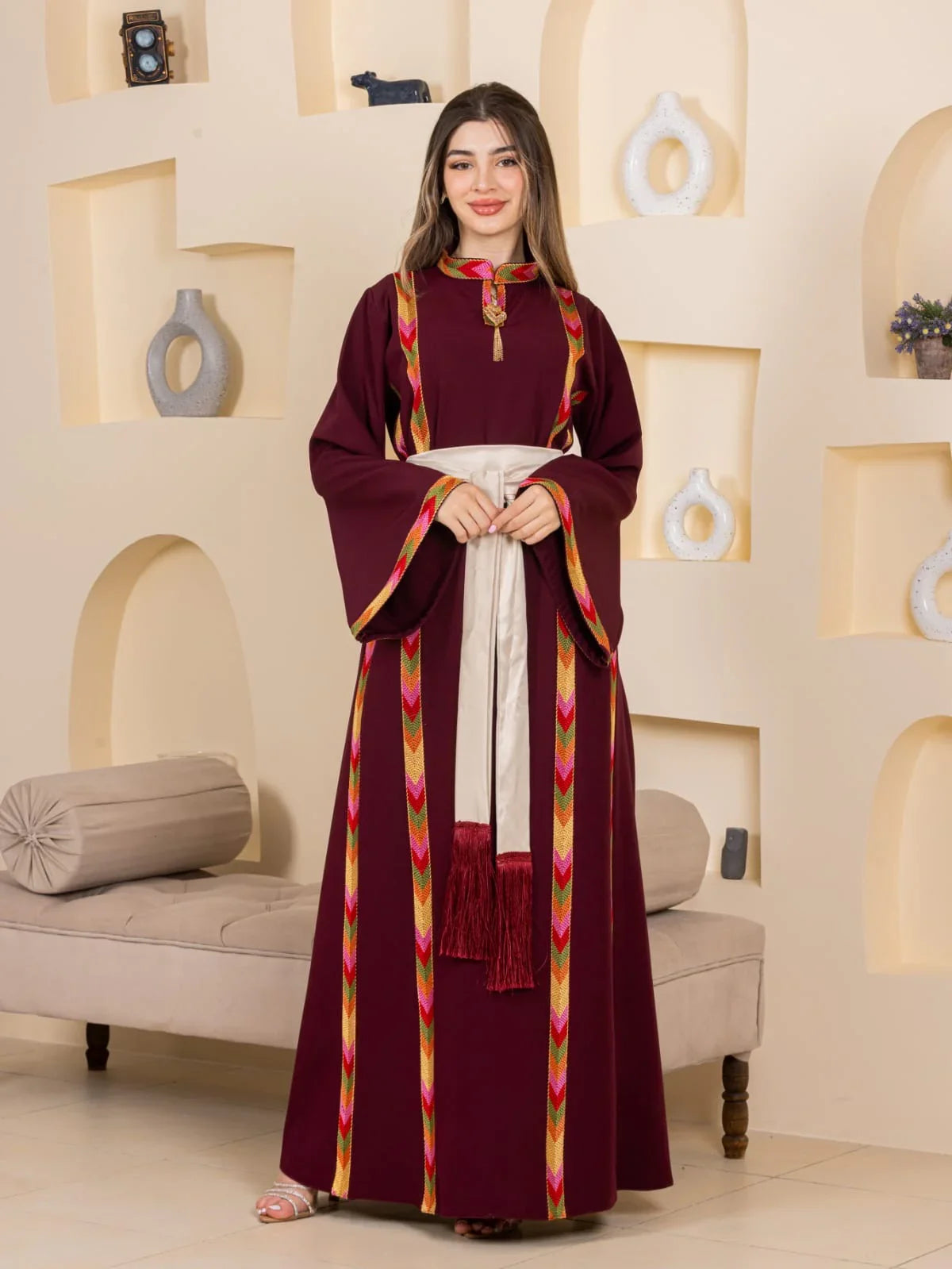 Embroiderd Thoub Al-Manajel maroon embroidered Palestinian thobe with colorful trim and ivory sash belt by Palestinian Elegance