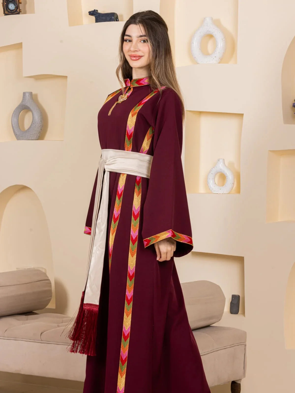 Maroon embroidered thobe with colorful chevron trim cream sash tassel Embroiderd Thoub Al-Manajel
