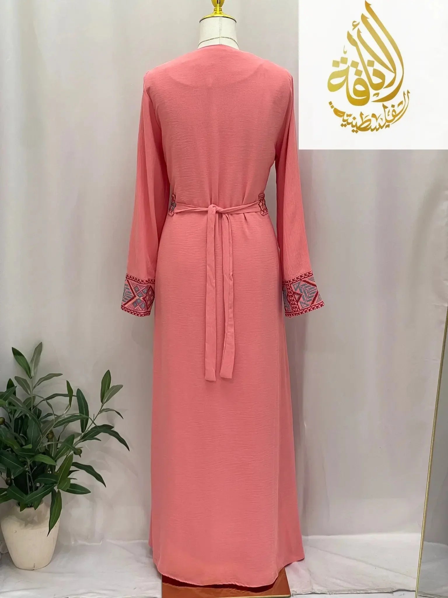 Back view of Palestinian Elegance pink embroidered 2Pcs Abaya with detailed sleeve embroidery and waist tie