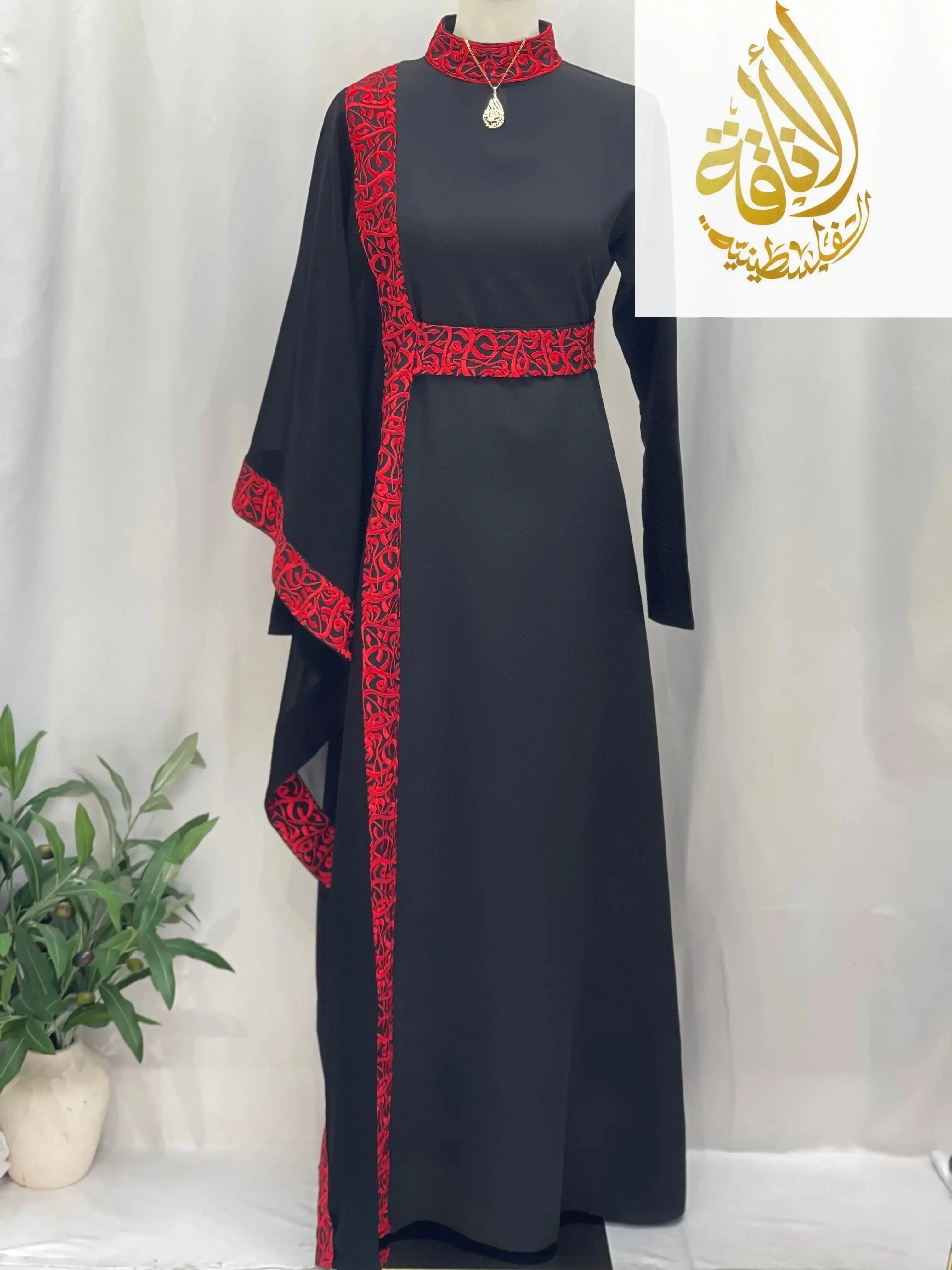 Palestinian Elegance embroidered abaya with Arabic letters in black with red detailed embroidery along the side and sleeves