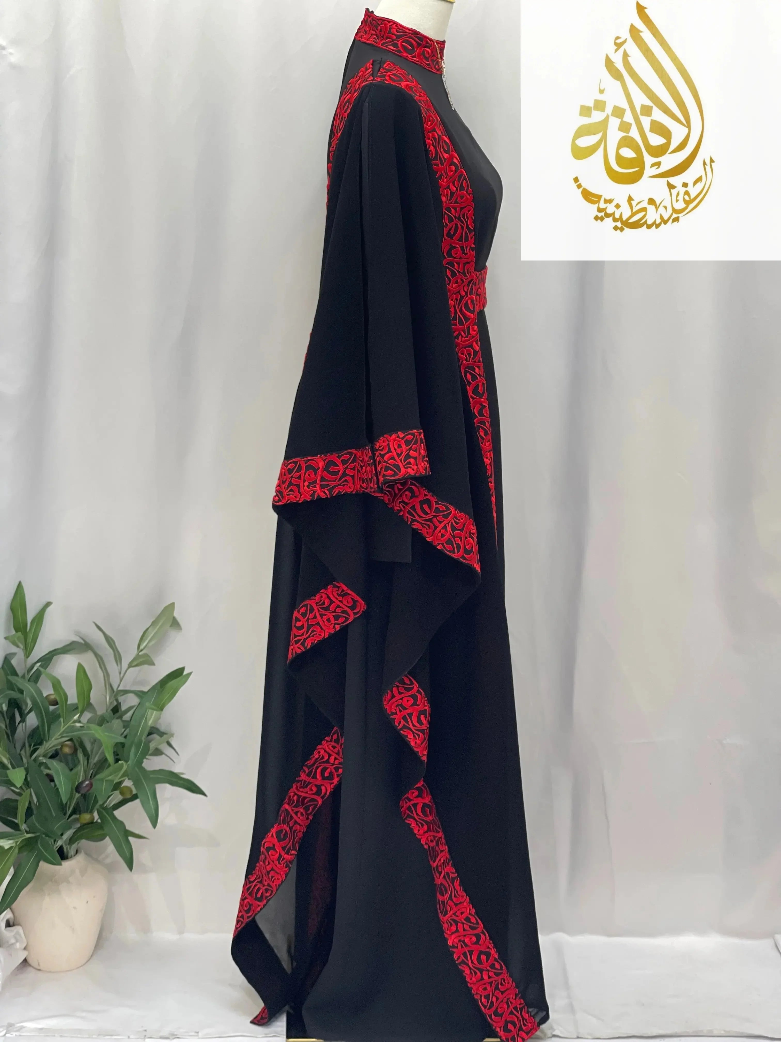 Palestinian Elegance embroidered abaya with Arabic letters in black fabric with red detailed embroidery on sleeves and edges