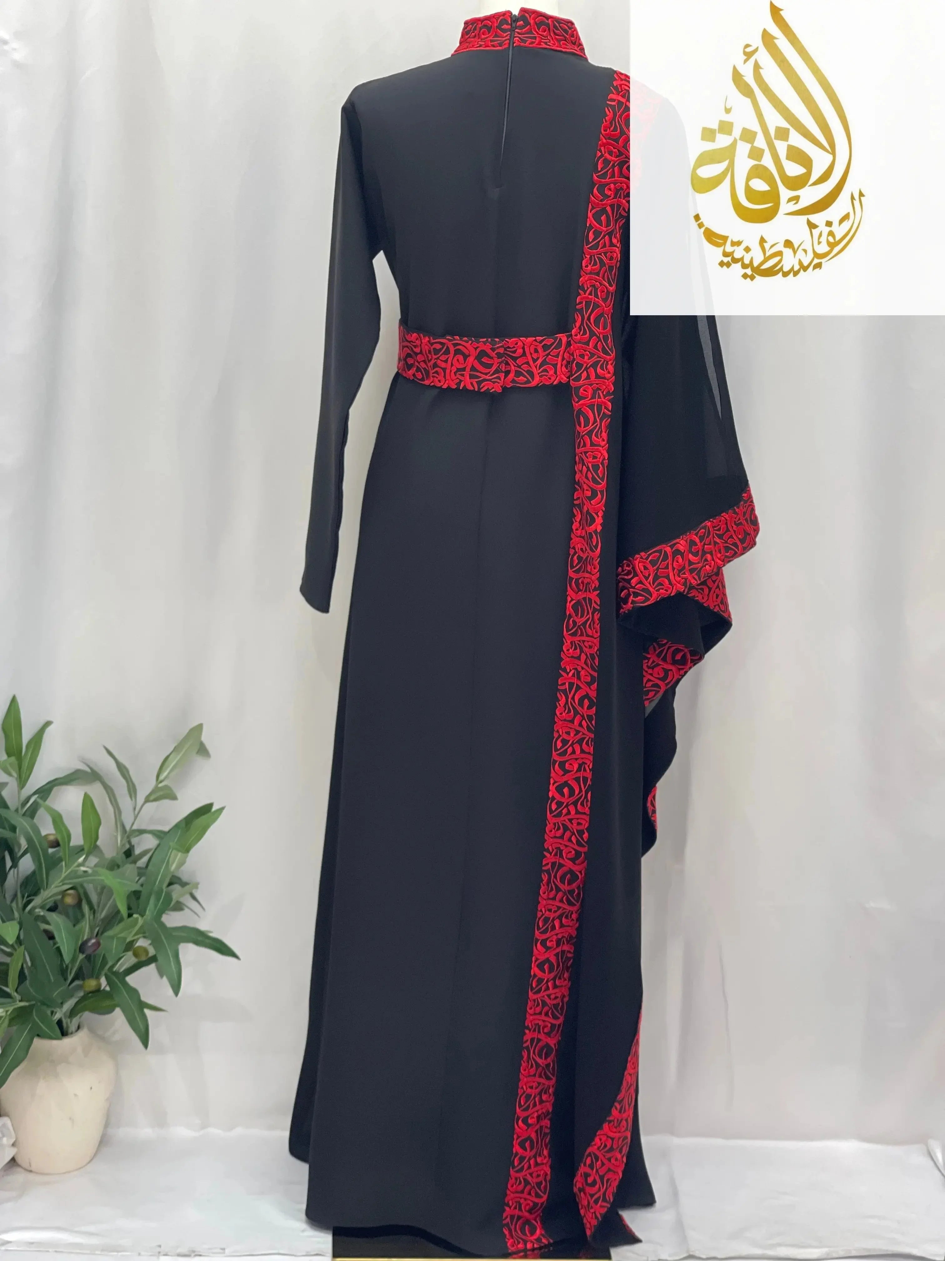 Black embroidered abaya with Arabic letters and red detailed trim by Palestinian Elegance