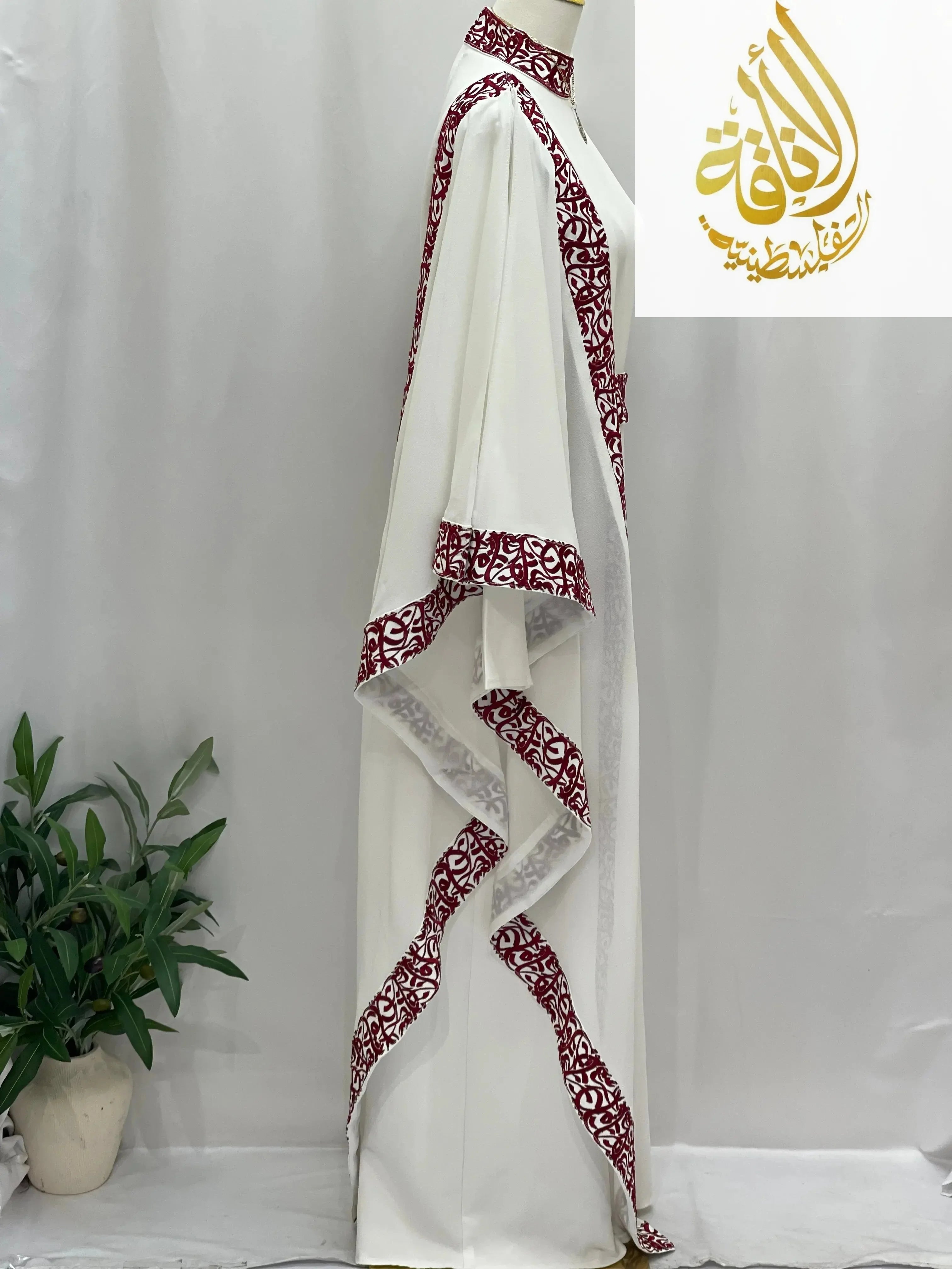 Palestinian Elegance embroidered abaya with Arabic letters in white featuring intricate maroon embroidery along edges