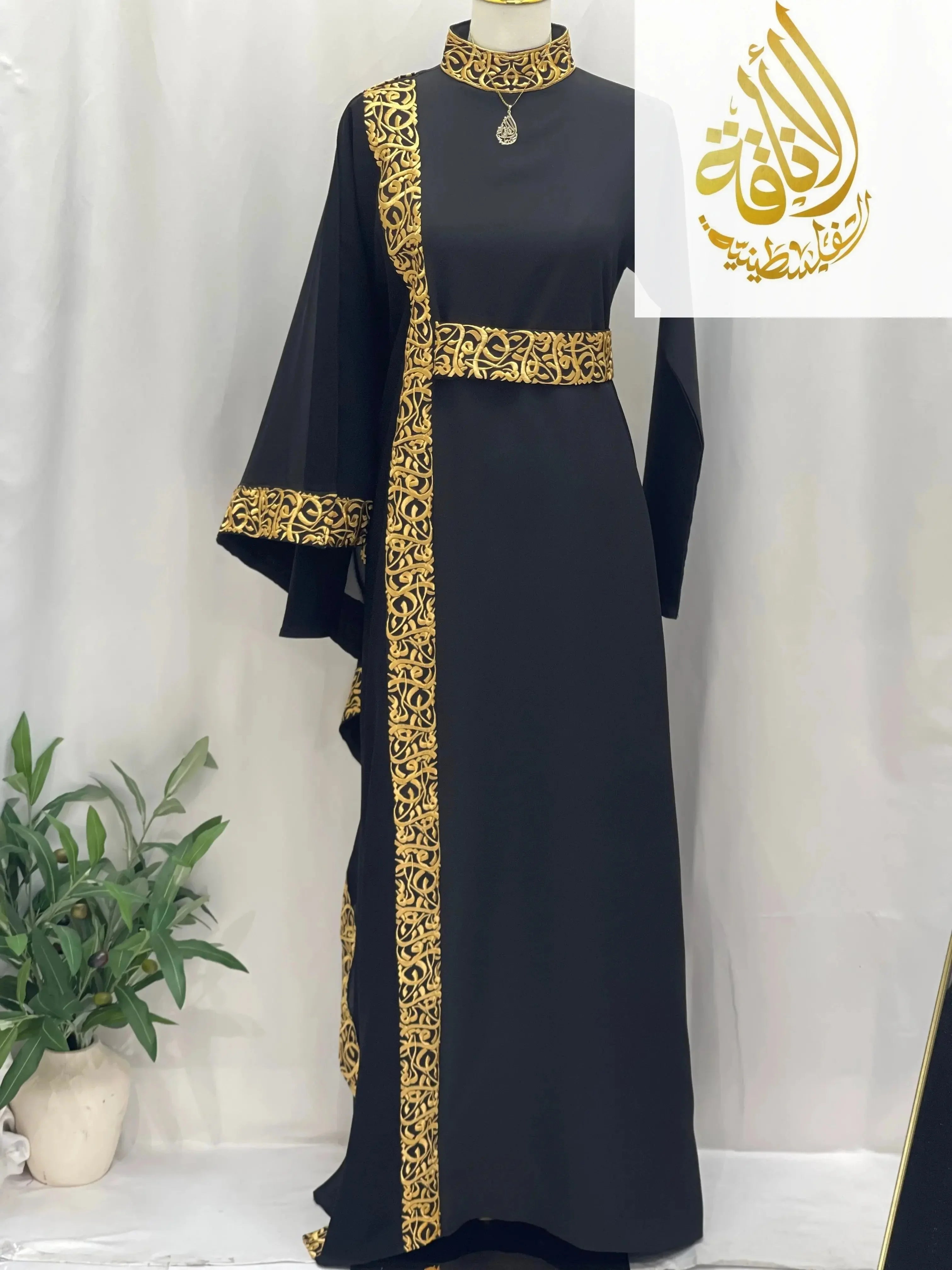 Black embroidered abaya with Arabic letters on collar, sleeve cuffs, and vertical trim by Palestinian Elegance