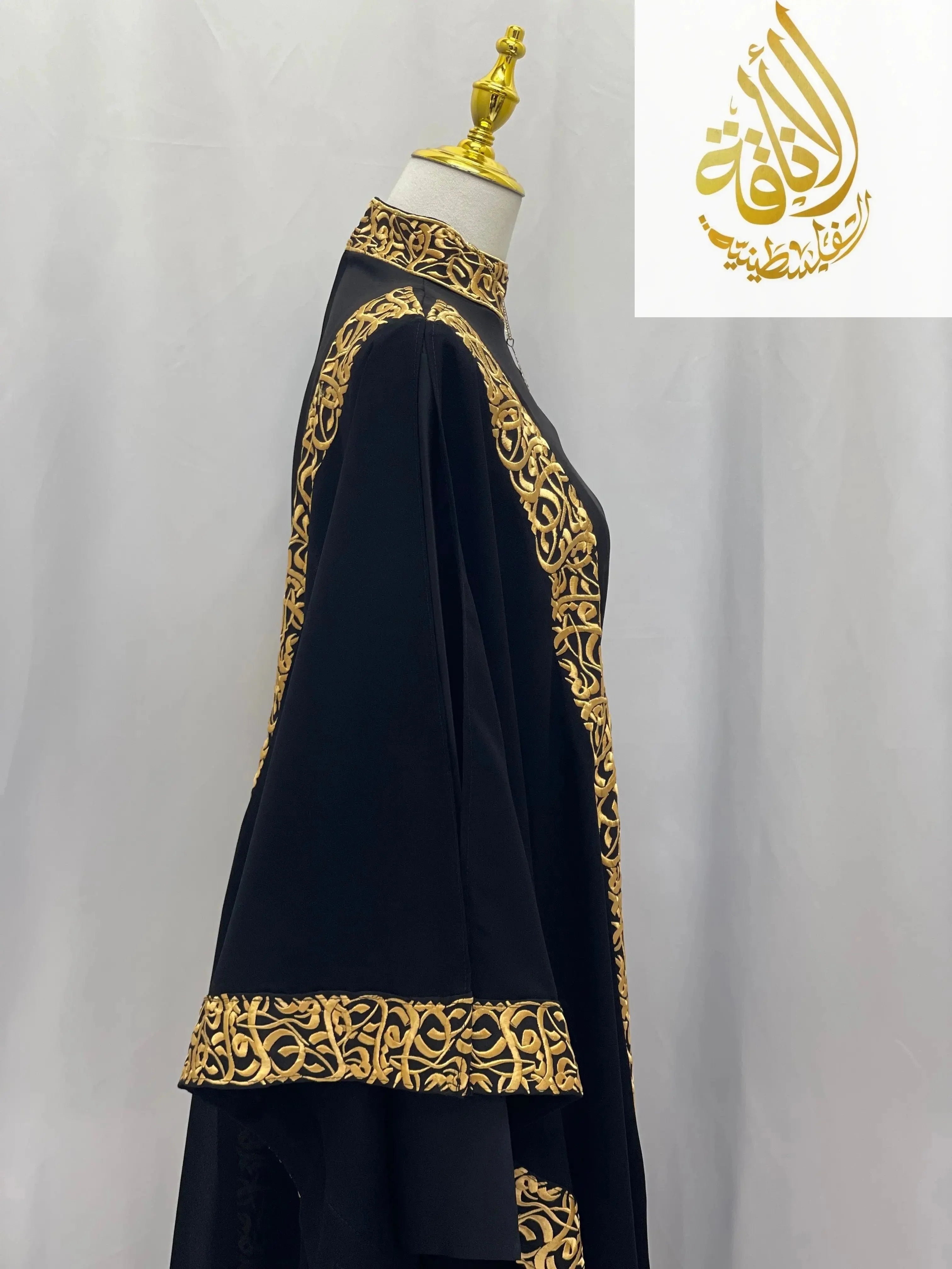 Palestinian Elegance black embroidered abaya with Arabic letters in gold detailing on sleeves and collar