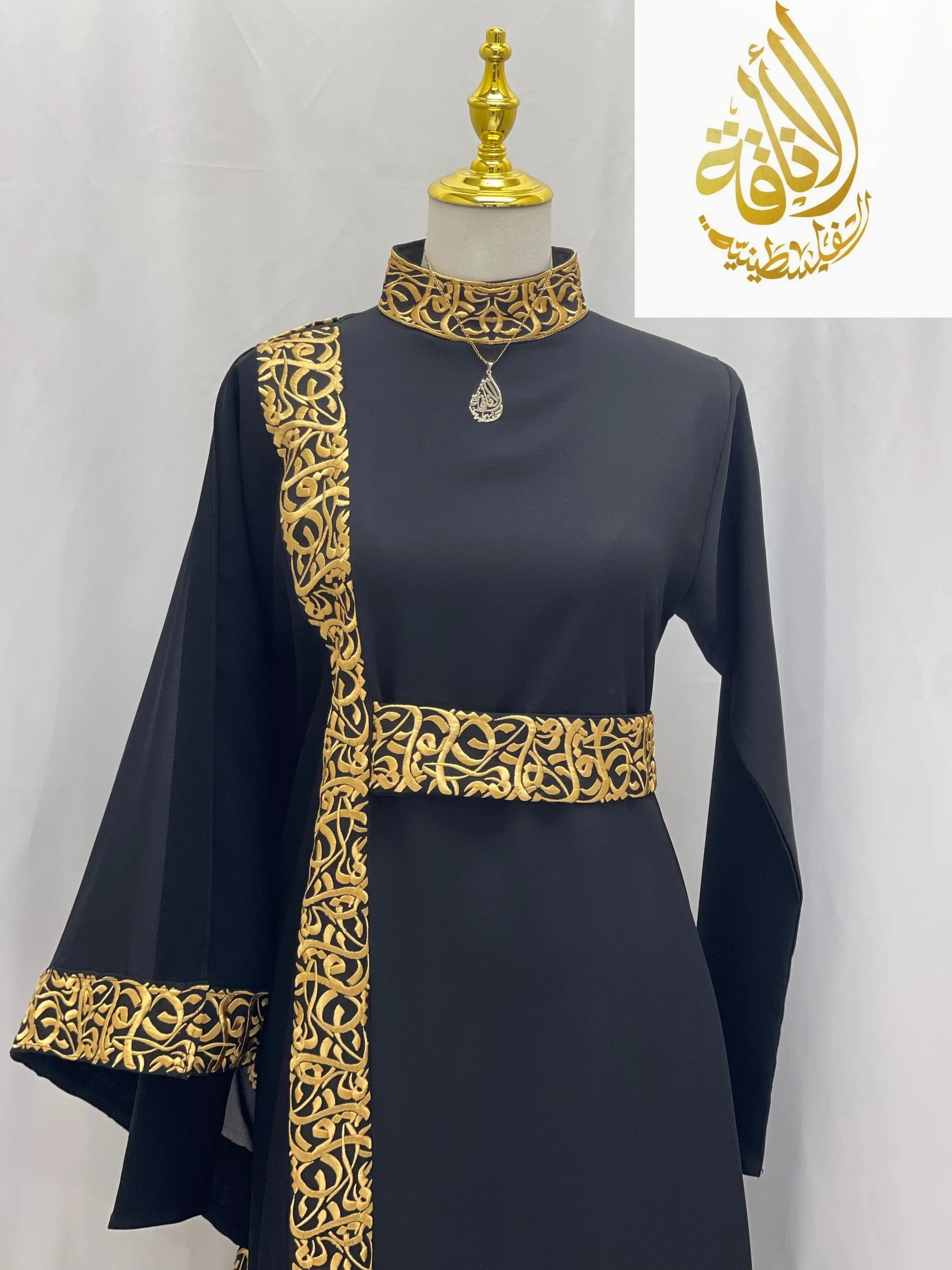 Palestinian Elegance black embroidered abaya with Arabic letters gold detailing on collar sleeves and waist