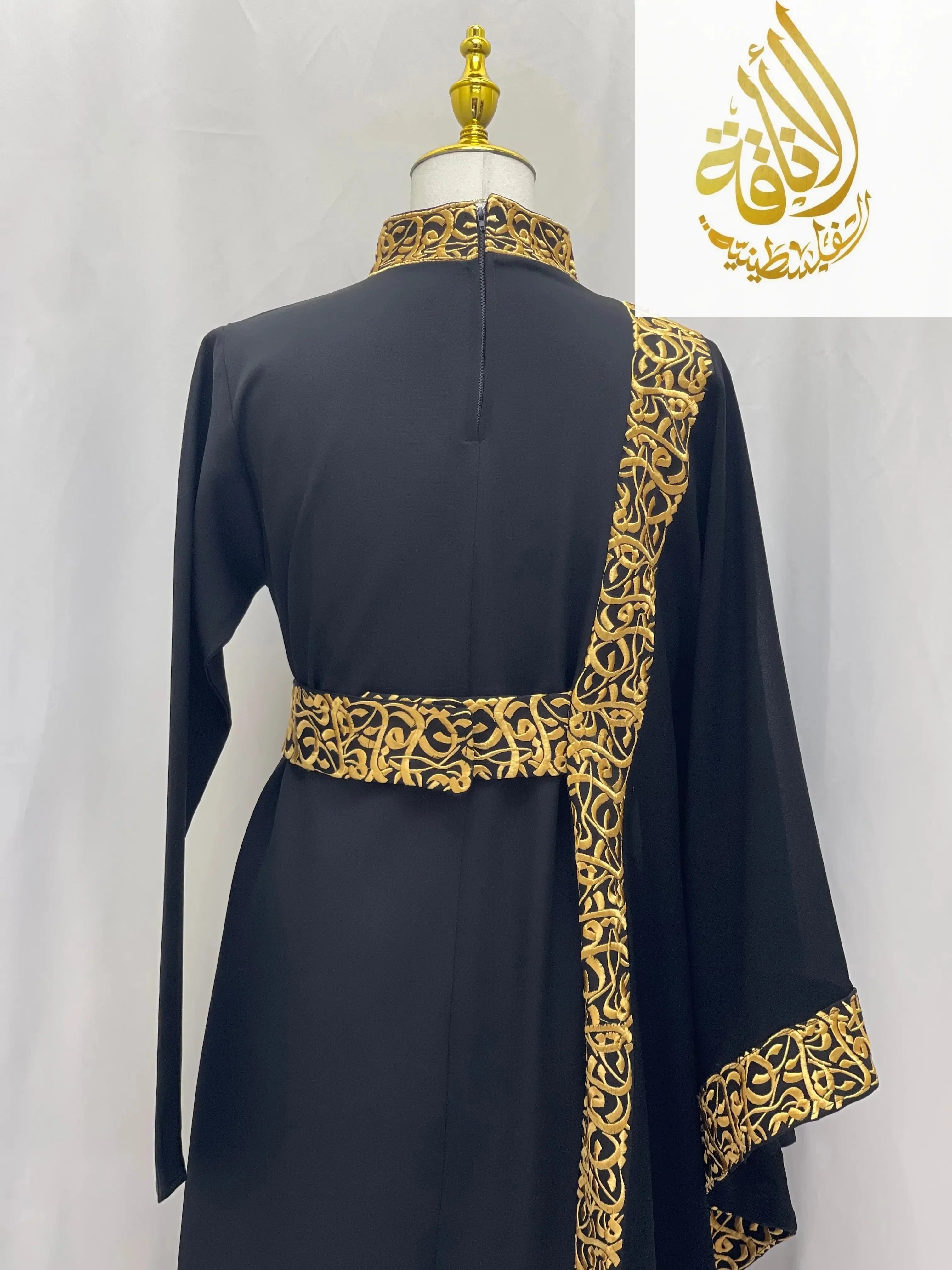 Elegant black embroidered abaya with Arabic letters in gold detailing on collar, sleeve, and belt by Palestinian Elegance