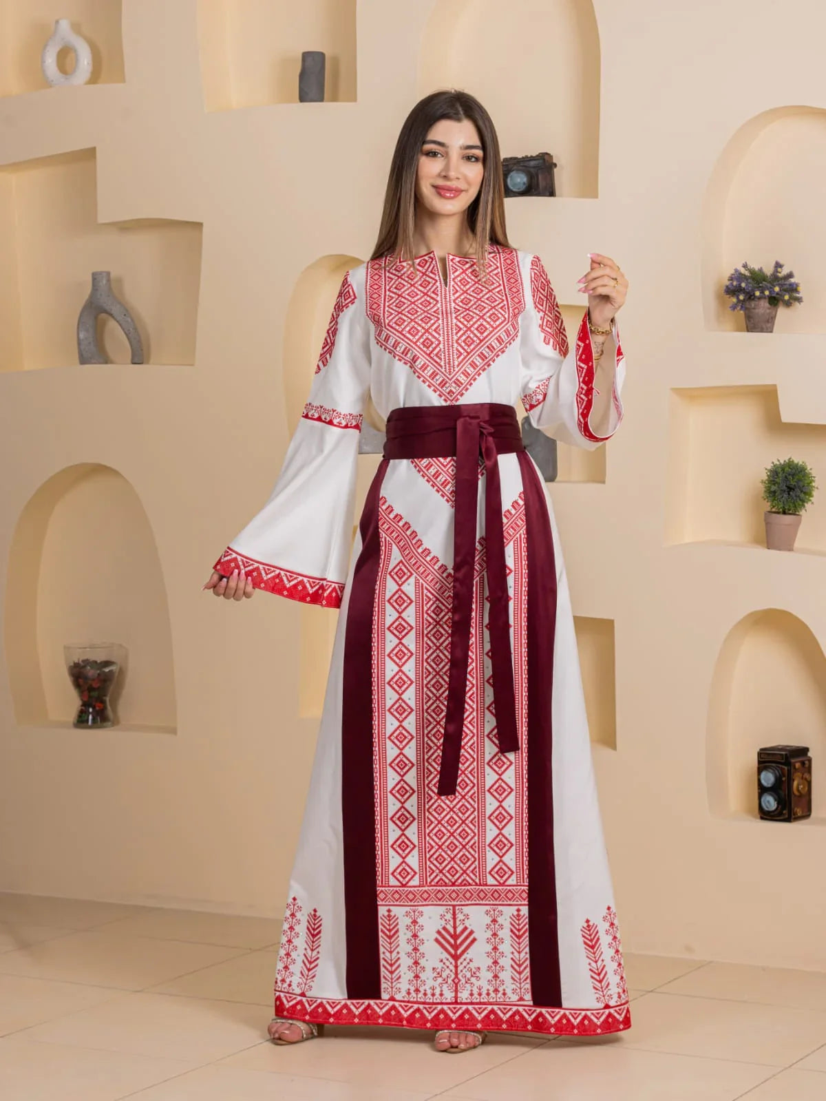 Embroidered Elegance Dress by Palestinian Elegance white floor length dress with red geometric embroidery and burgundy sash