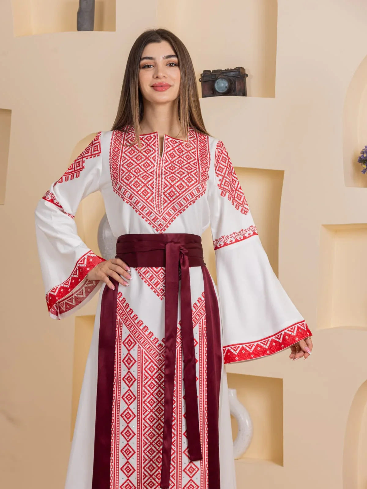 Embroidered Elegance Dress by Palestinian Elegance white dress with red geometric embroidery bell sleeves and burgundy sash belt