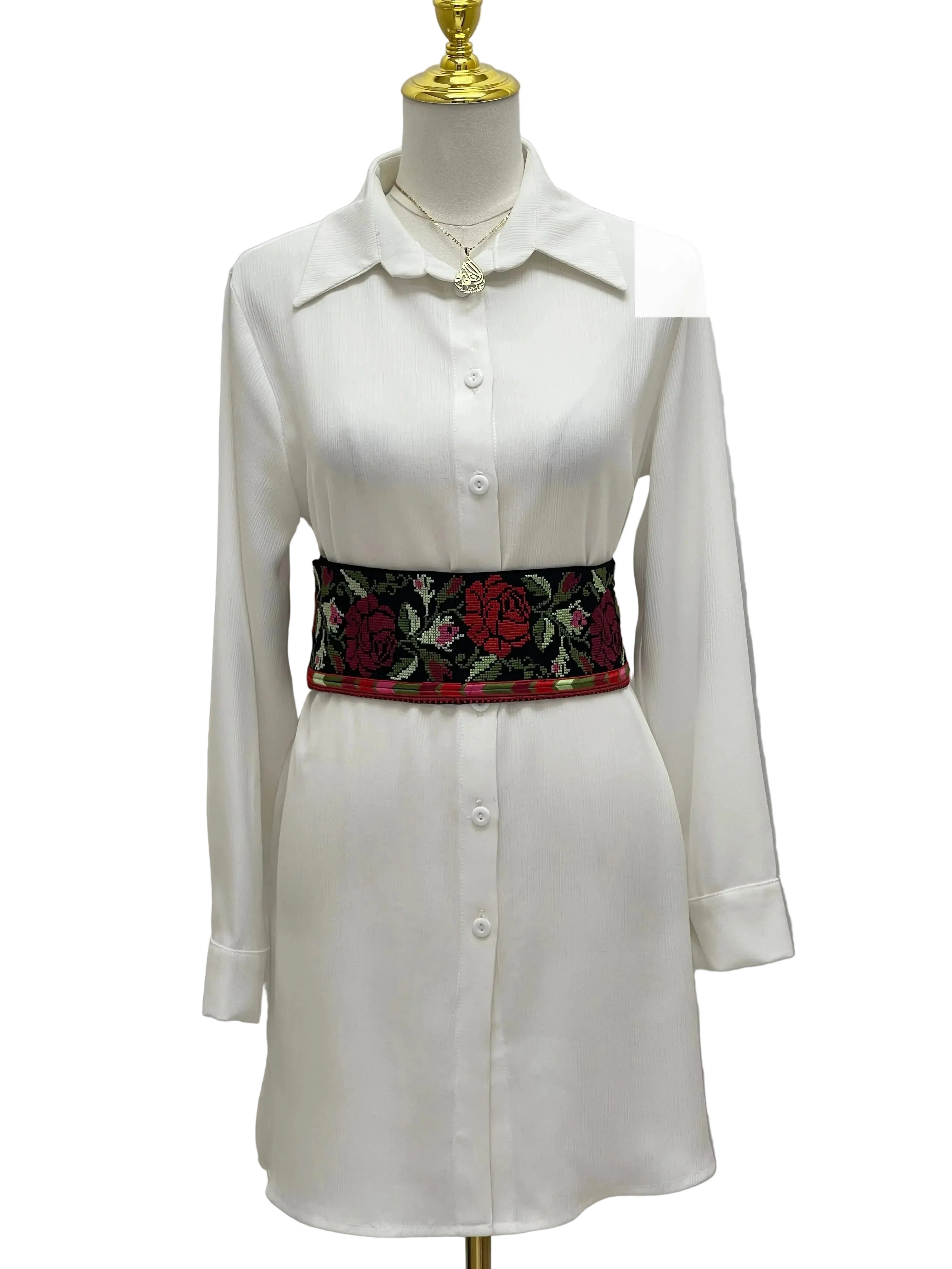 Palestinian Elegance Embroidered Heritage Belt with red and green floral design worn over white shirt dress
