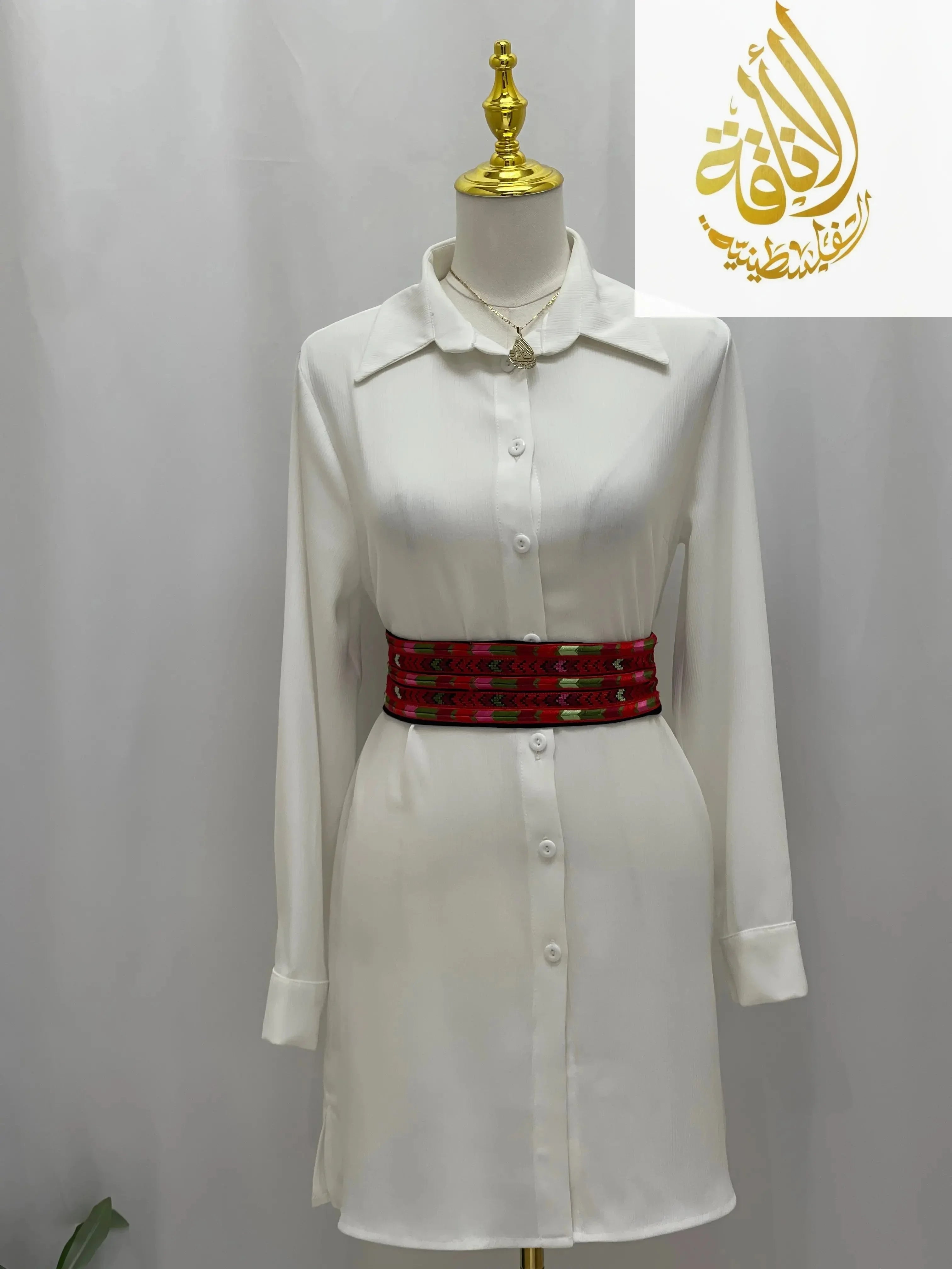 Embroidered Heritage Belt by Palestinian Elegance worn over a white button-up dress with long sleeves