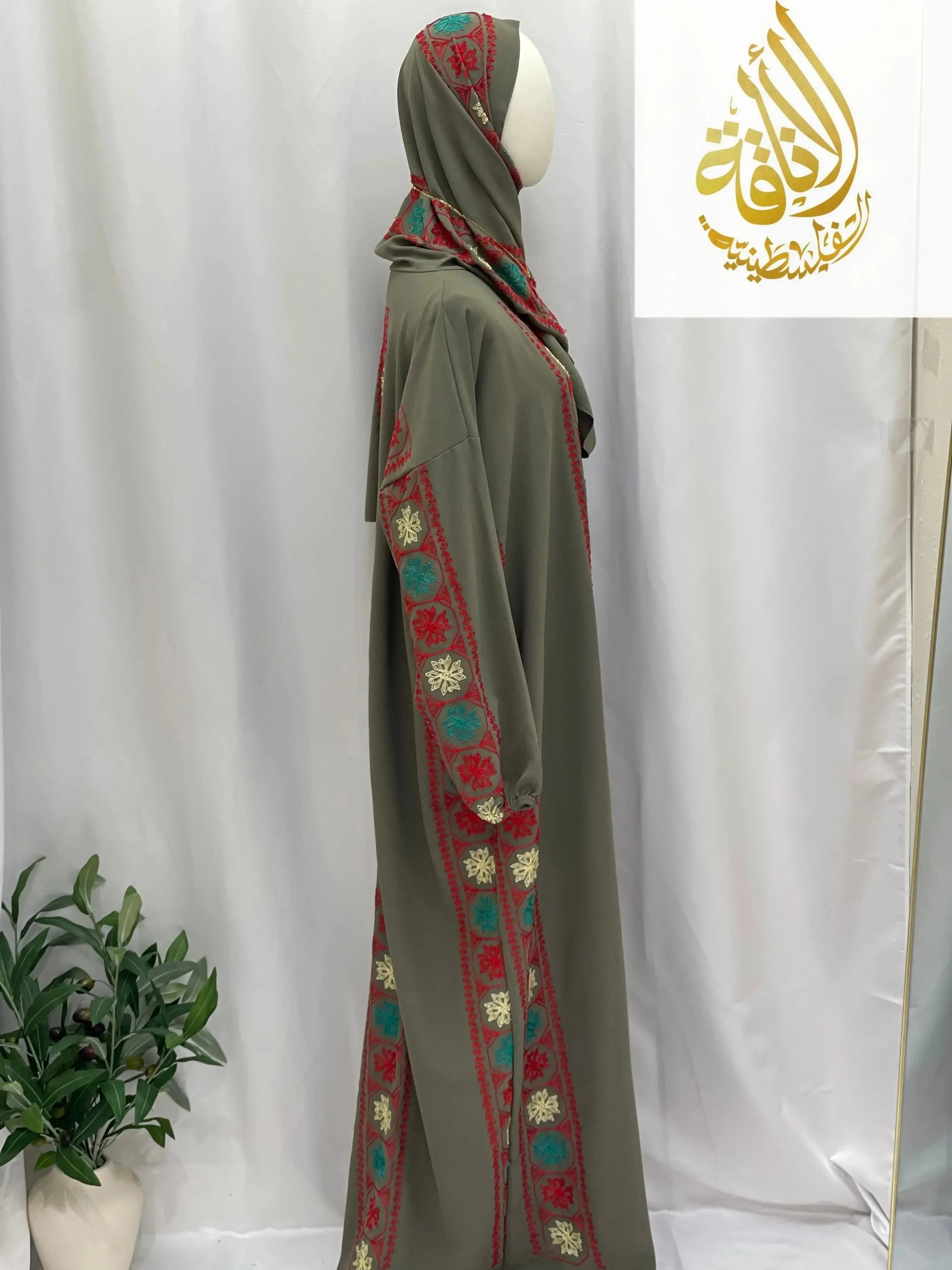 Palestinian Elegance embroidered prayer dress in olive green with red and turquoise traditional embroidery details