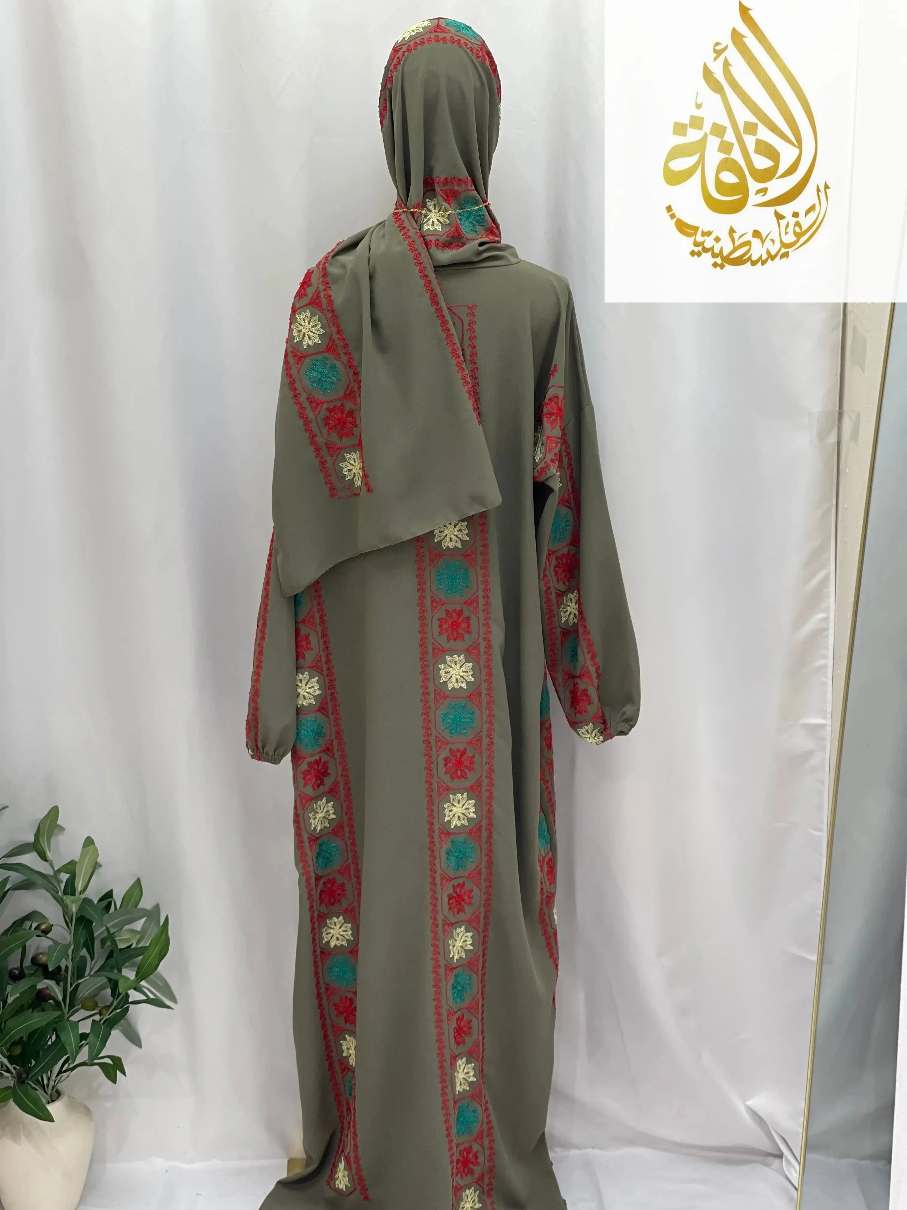 Palestinian Elegance embroidered prayer dress in olive green with red and turquoise floral embroidery and matching headscarf
