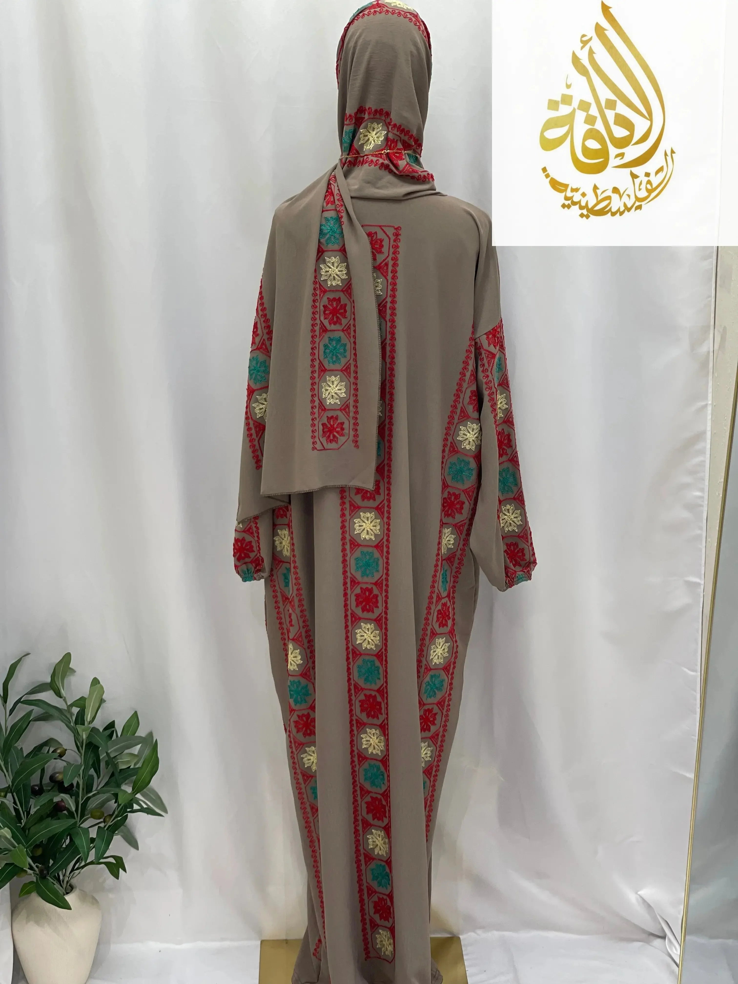 Palestinian Elegance embroidered prayer dress with colorful floral embroidery on beige background