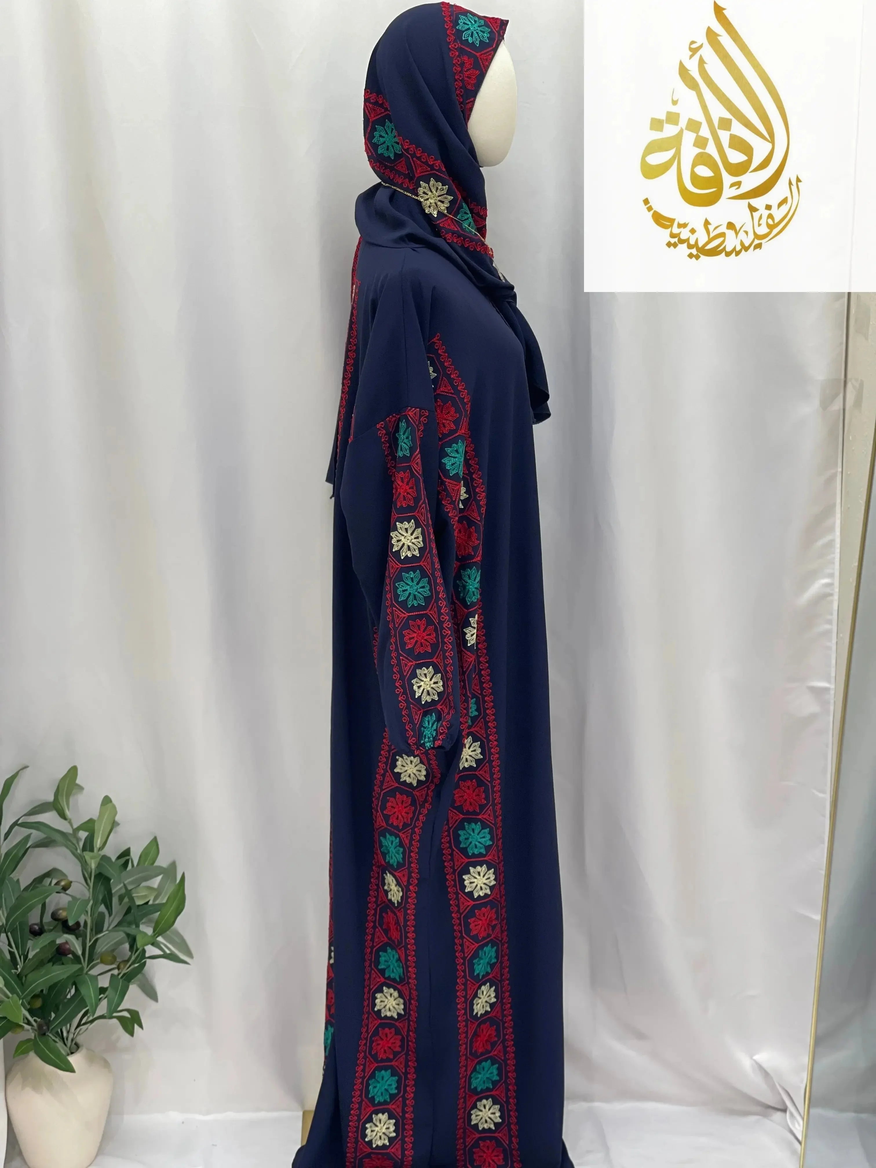Palestinian Elegance embroidered prayer dress in navy blue with colorful floral embroidery on side and matching headscarf