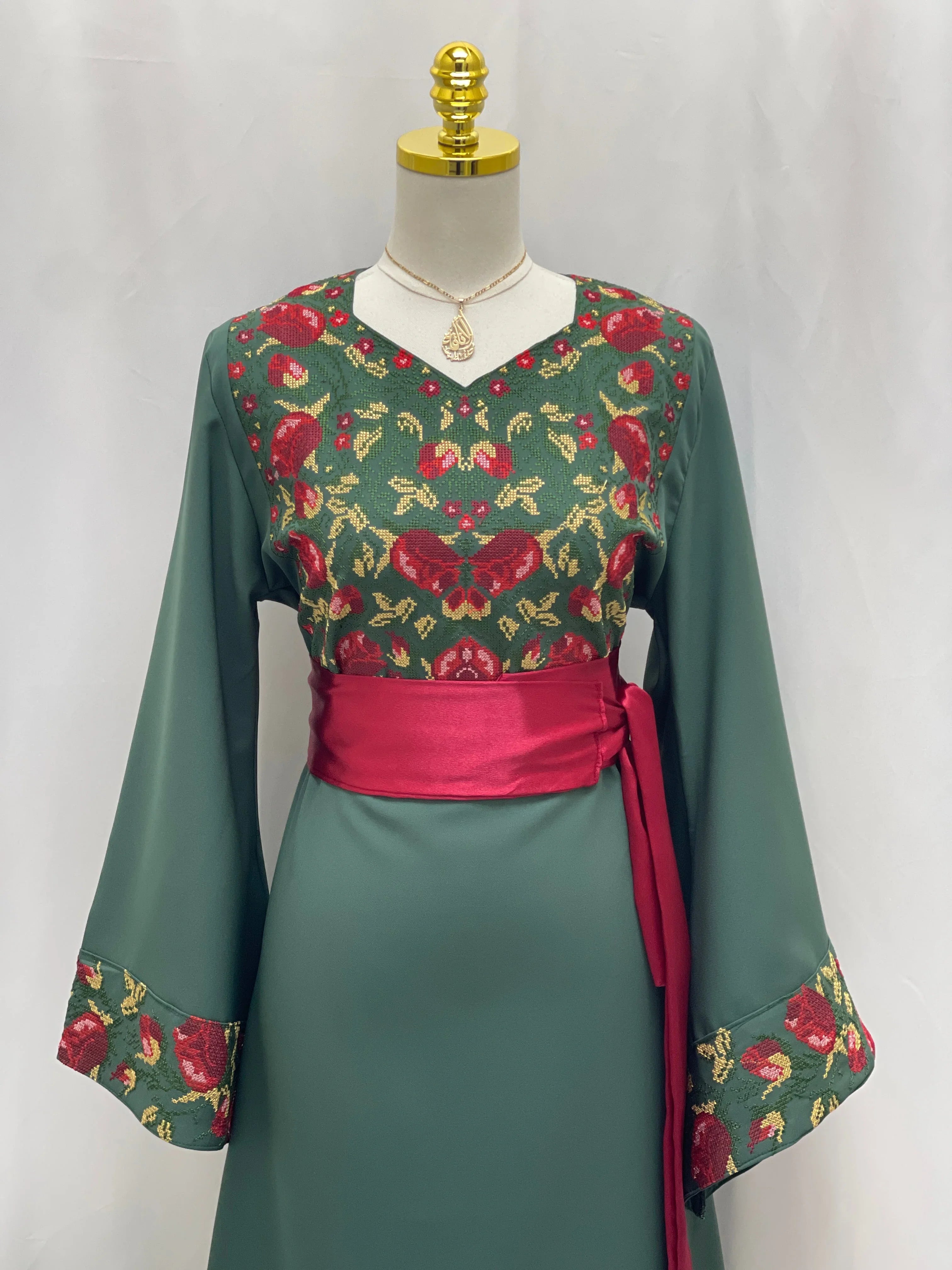 Palestinian Elegance Emerald Blossom EmbroideredThobe green long thobe with red floral embroidery on bodice cuffs and waist sash