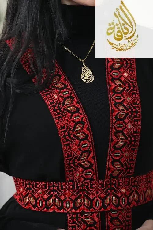Black top with intricate red and black Palestinian Elegance embroidery featuring geometric and floral patterns
