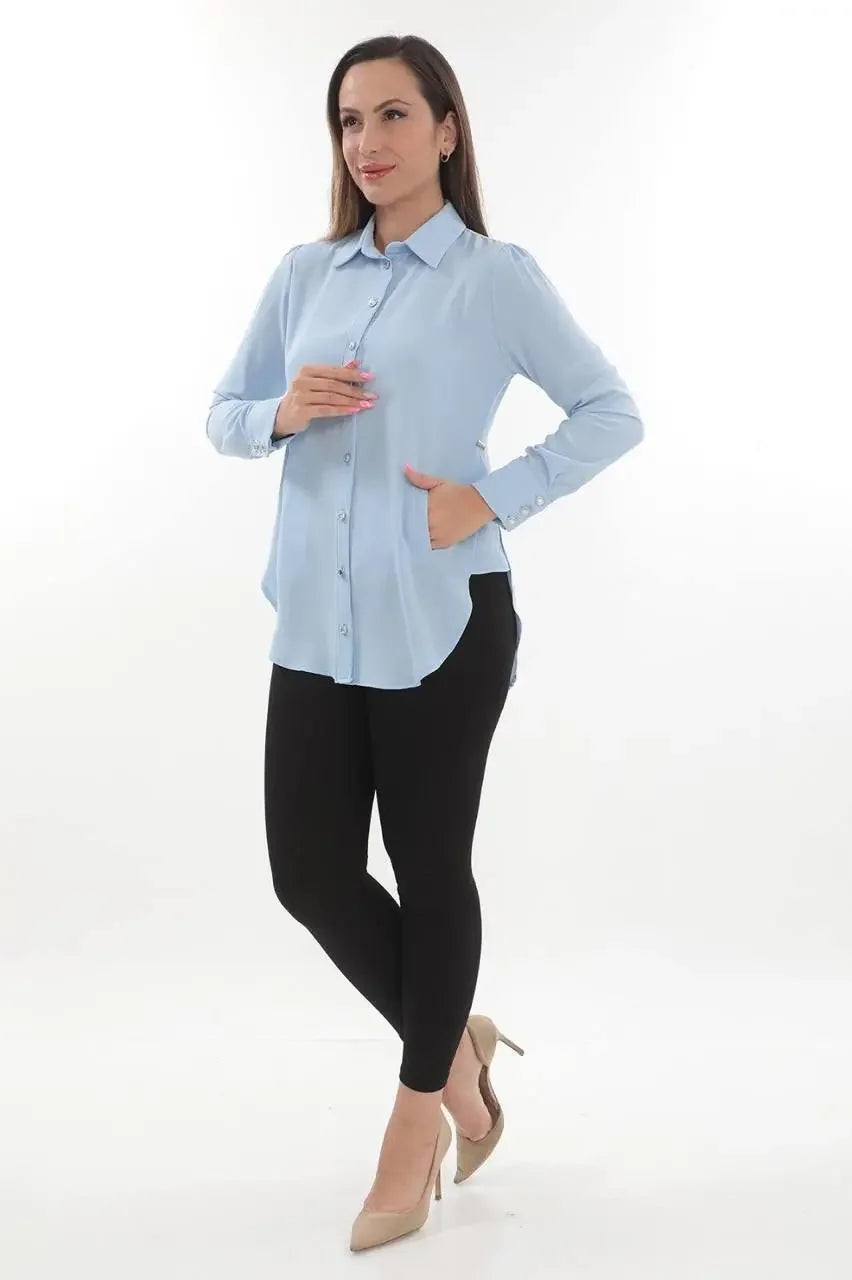 Palestinian Elegance casual light blue embroidered blouse for women paired with black pants and beige heels