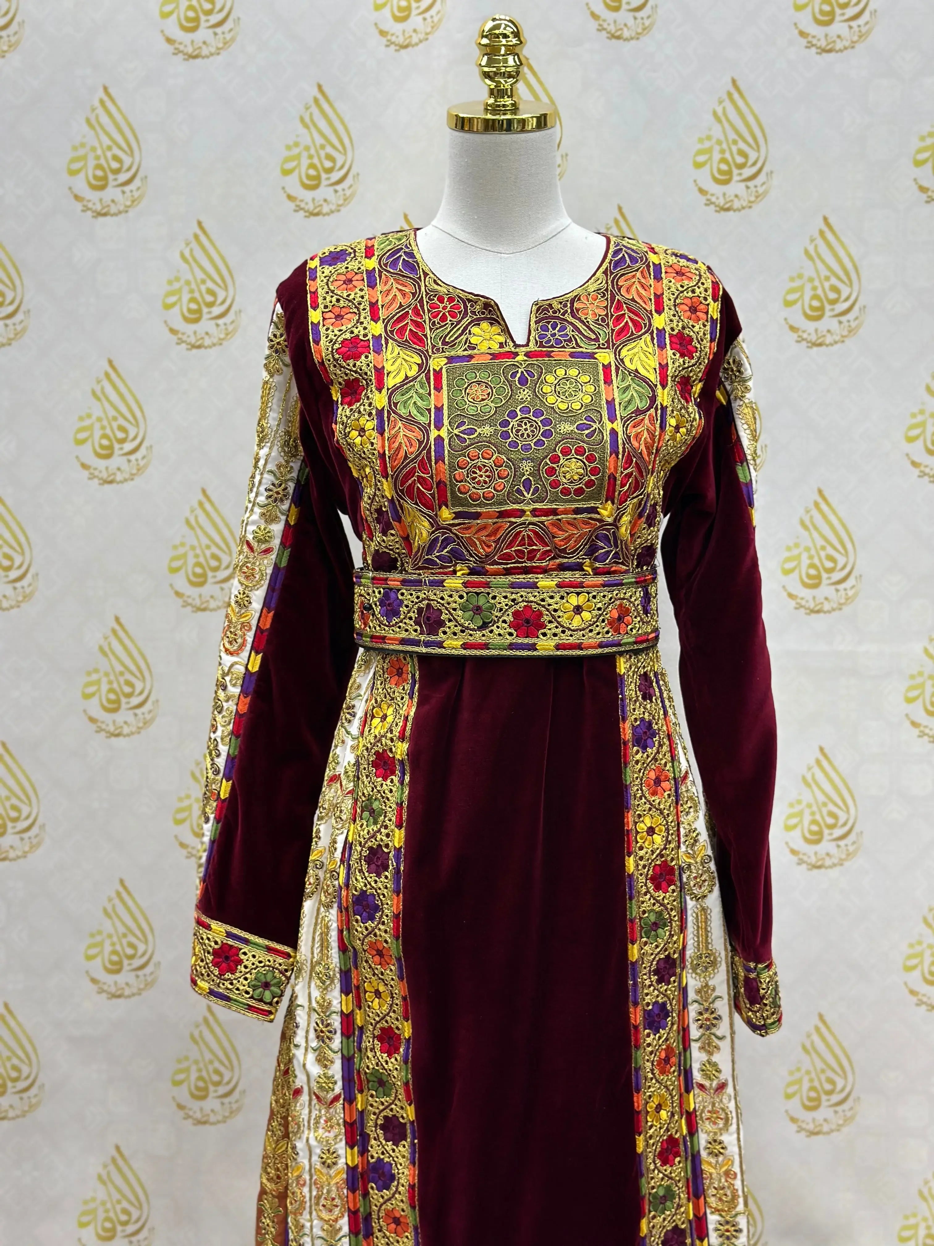 Velvet Palestinian dress with intricate colorful embroidery on sleeves and bodice by Palestinian Elegance