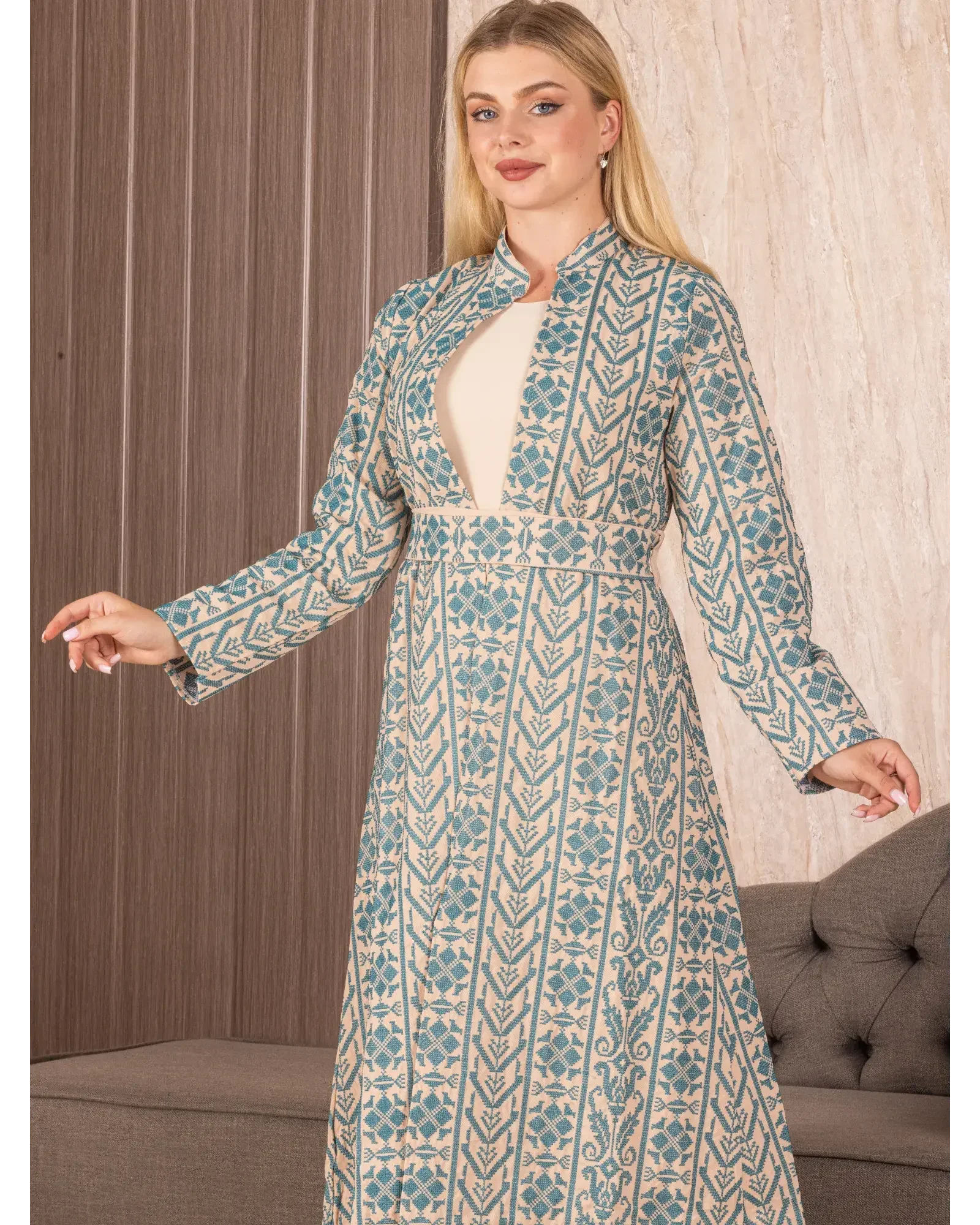 Palestinian Elegance embroidered long cardigan with blue geometric floral patterns on beige fabric