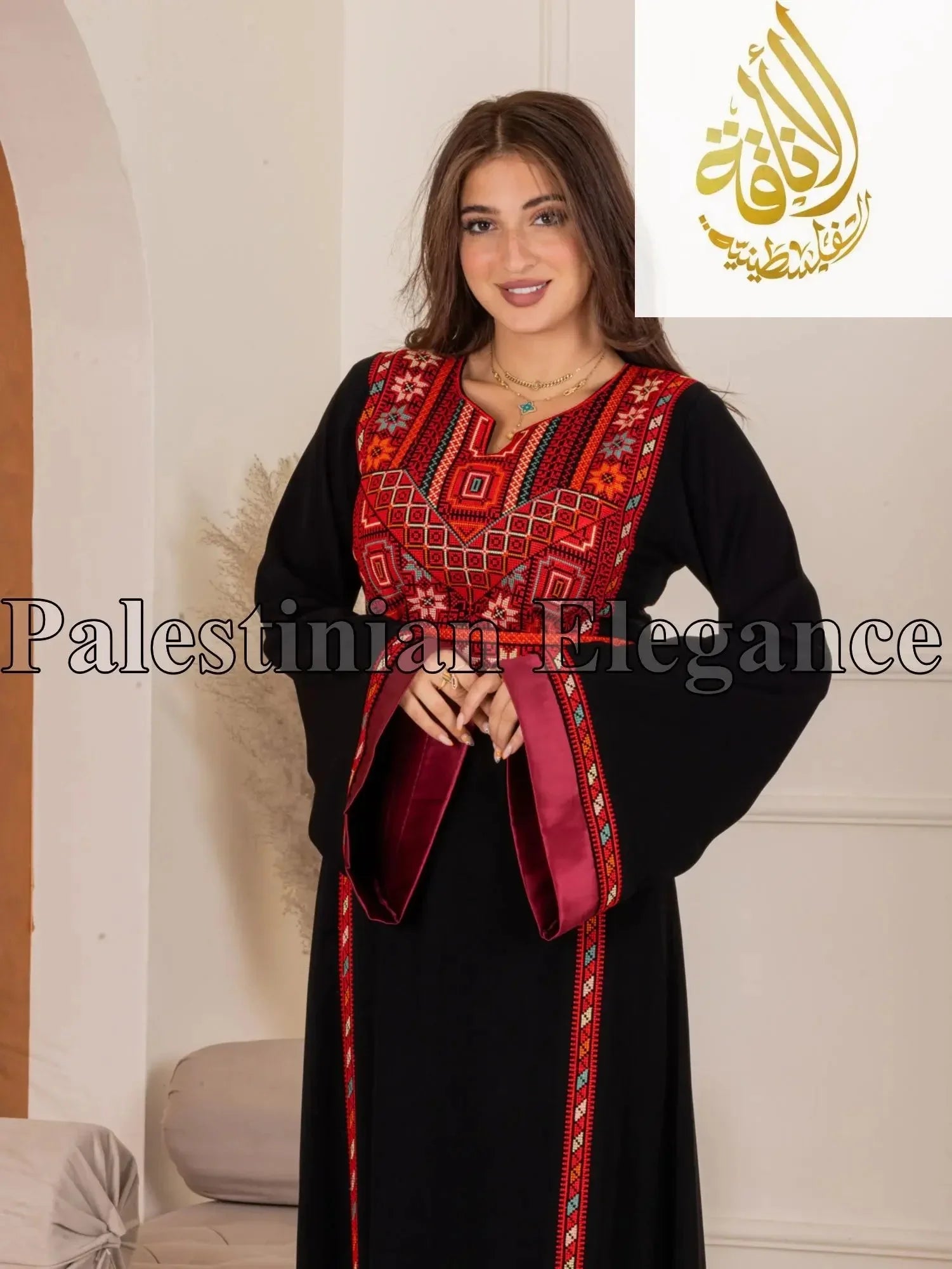 Woman wearing a black Fadwa Embroidered Thoub with red and intricate traditional embroidery by Palestinian Elegance