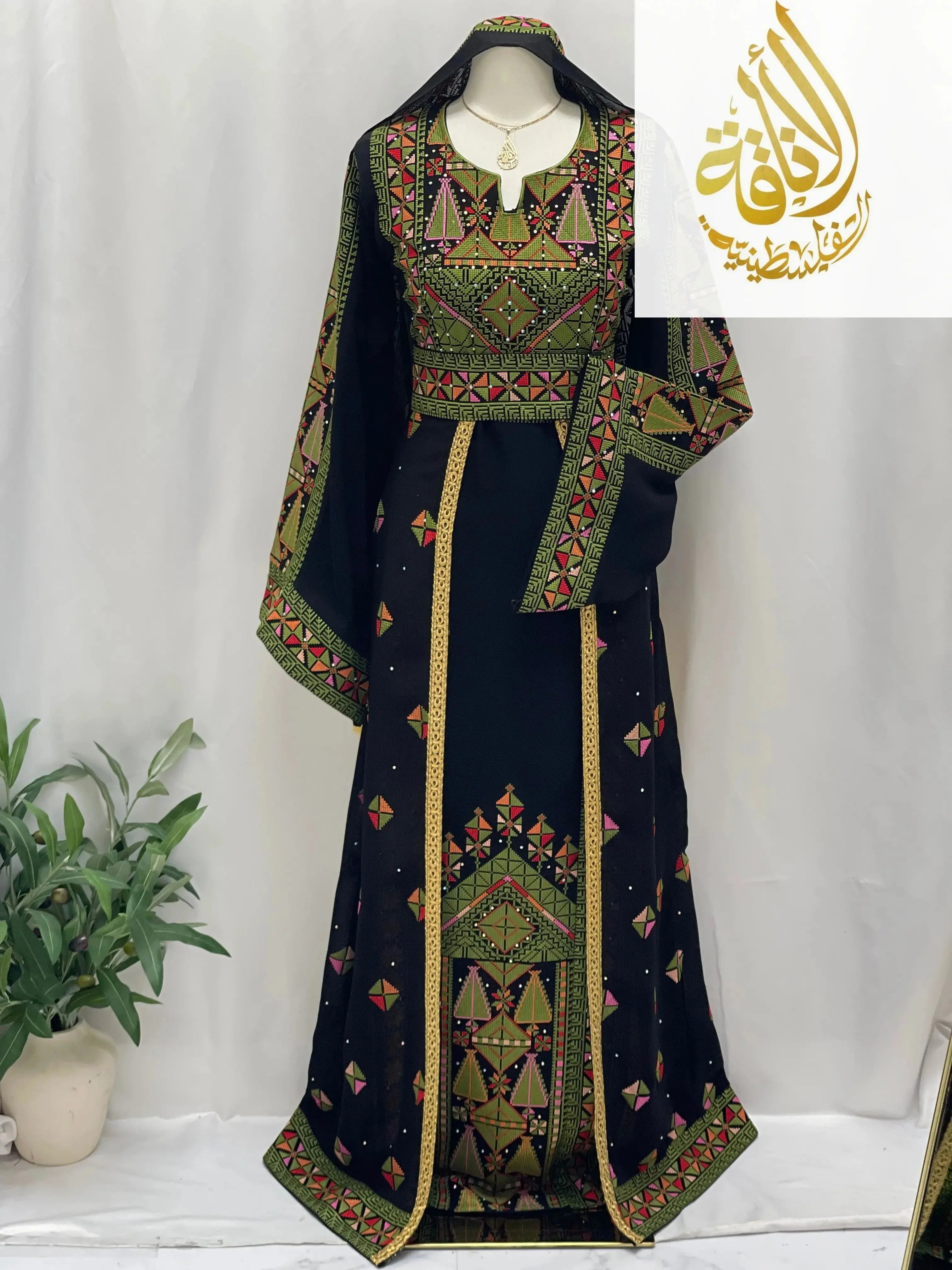 Embroidered Falahi thoub with overskirt by Palestinian Elegance featuring traditional geometric patterns on black fabric