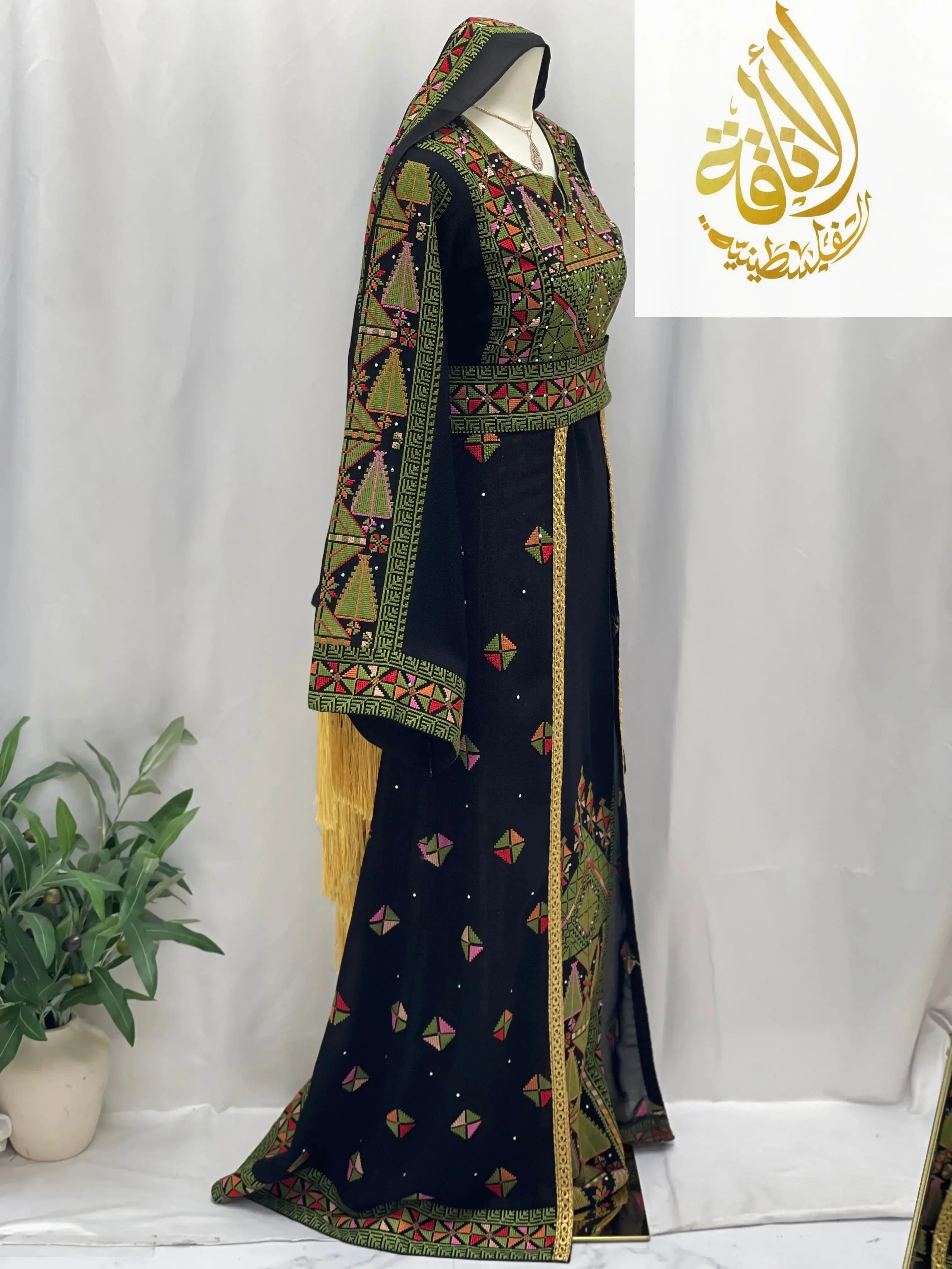 Palestinian Elegance embroidered Falahi thoub with overskirt featuring intricate geometric patterns in green and gold