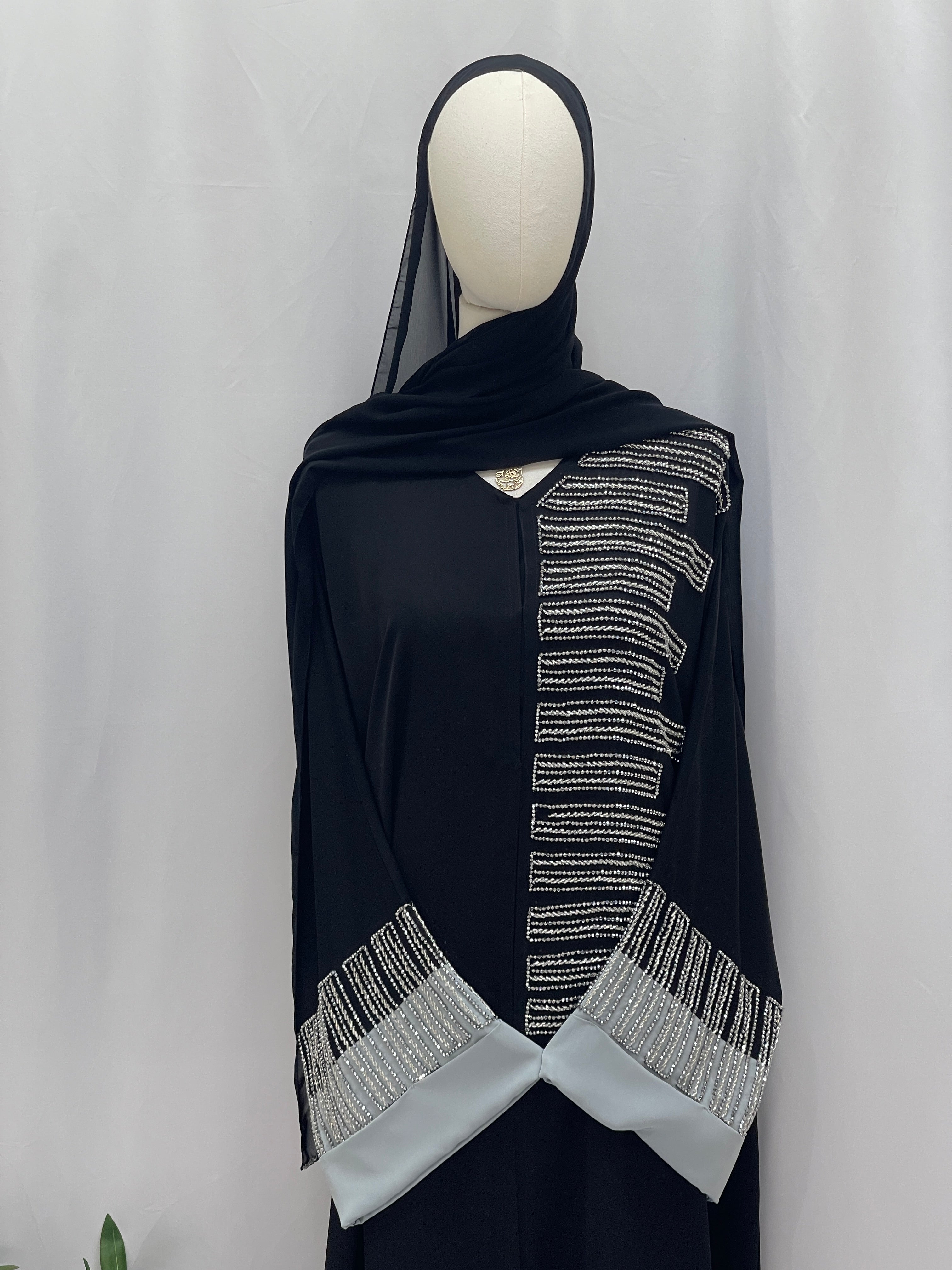 Palestinian Elegance Fancy Beads Dubai Abaya black abaya with silver beadwork vertical trim and embellished cuff panels