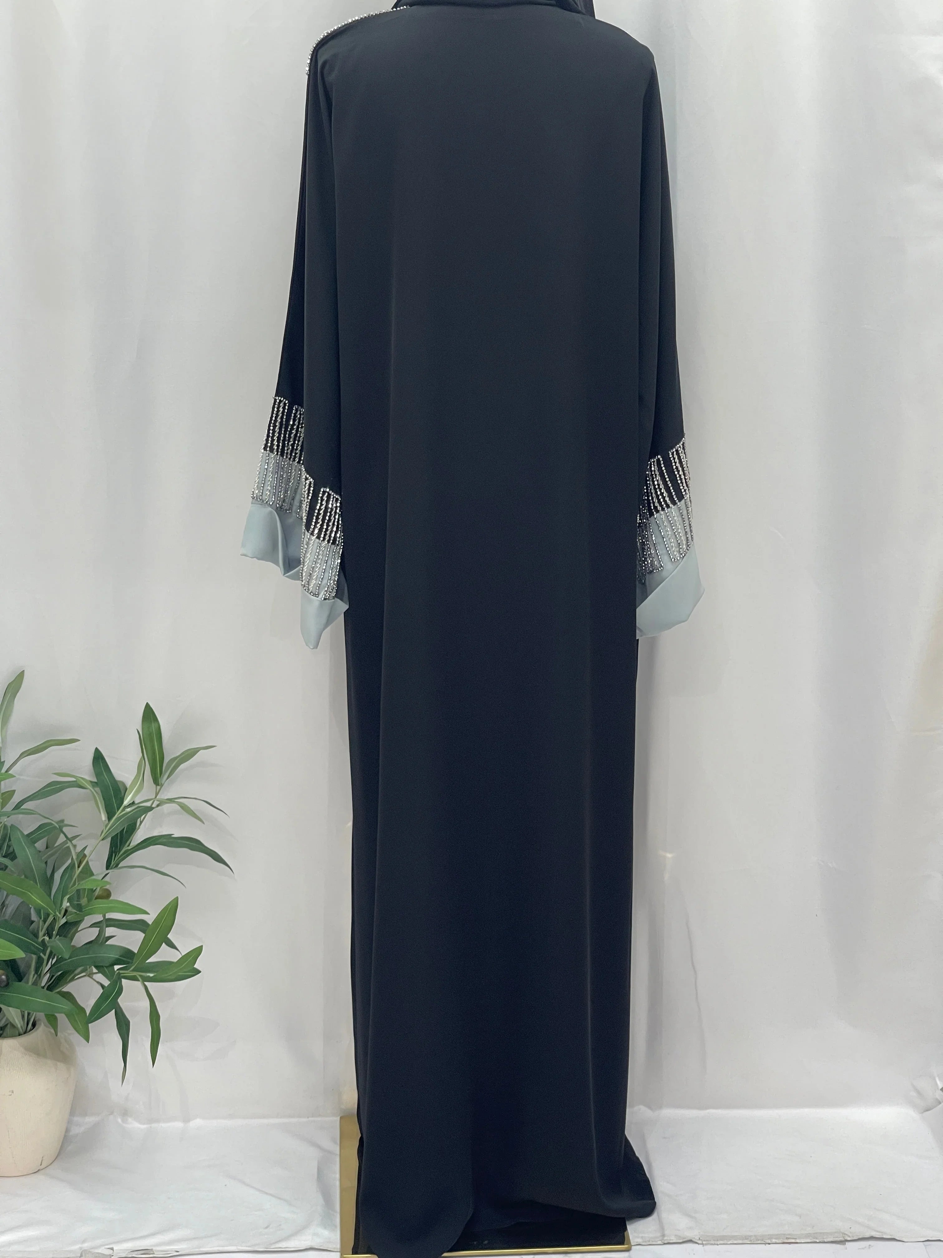 Palestinian Elegance black abaya back view featuring Fancy Beads Dubai Abaya embellished sleeves and light blue cuffs