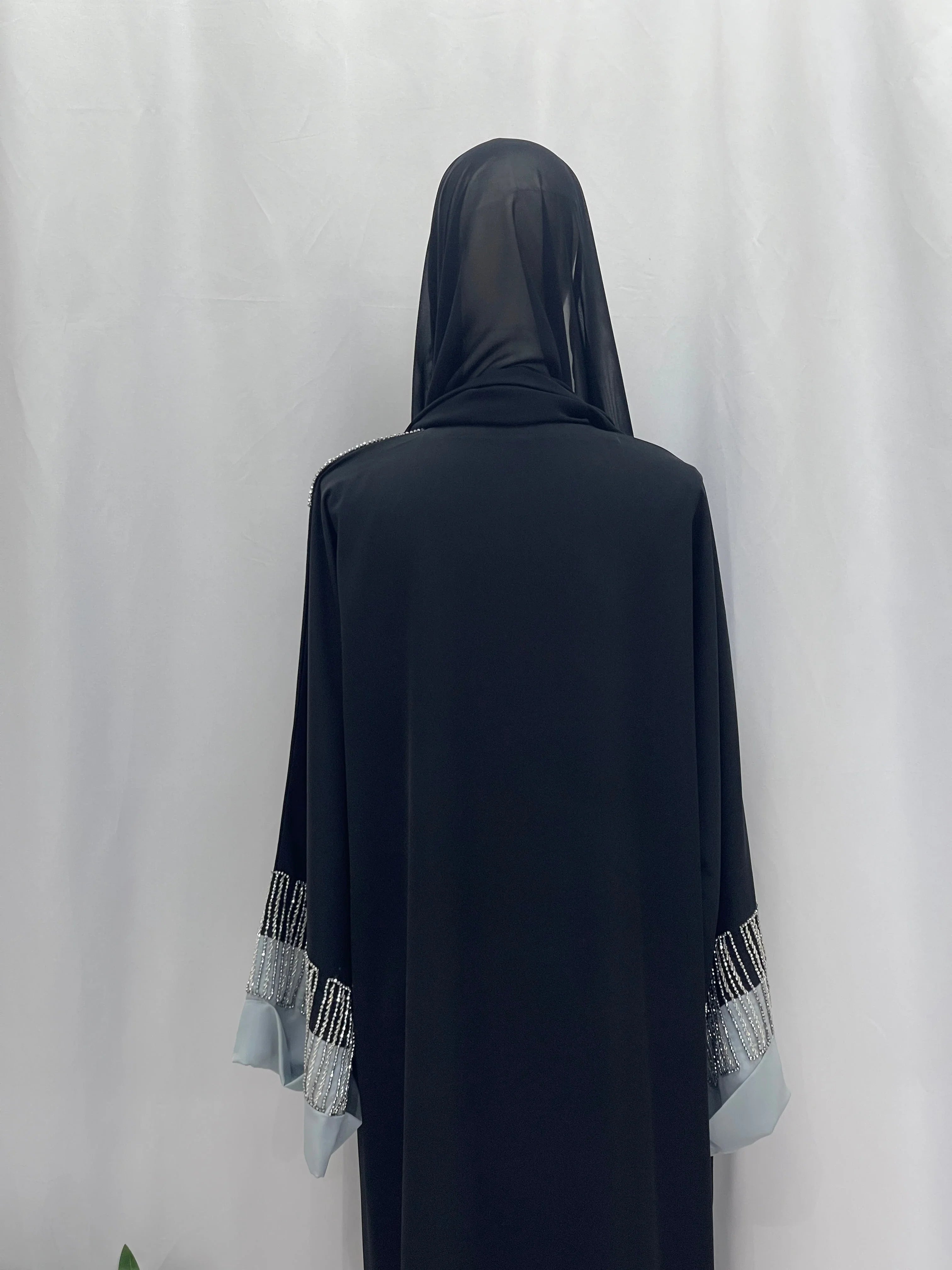 Palestinian Elegance Fancy Beads Dubai Abaya back view black abaya with sheer hijab and beaded blue cuffs