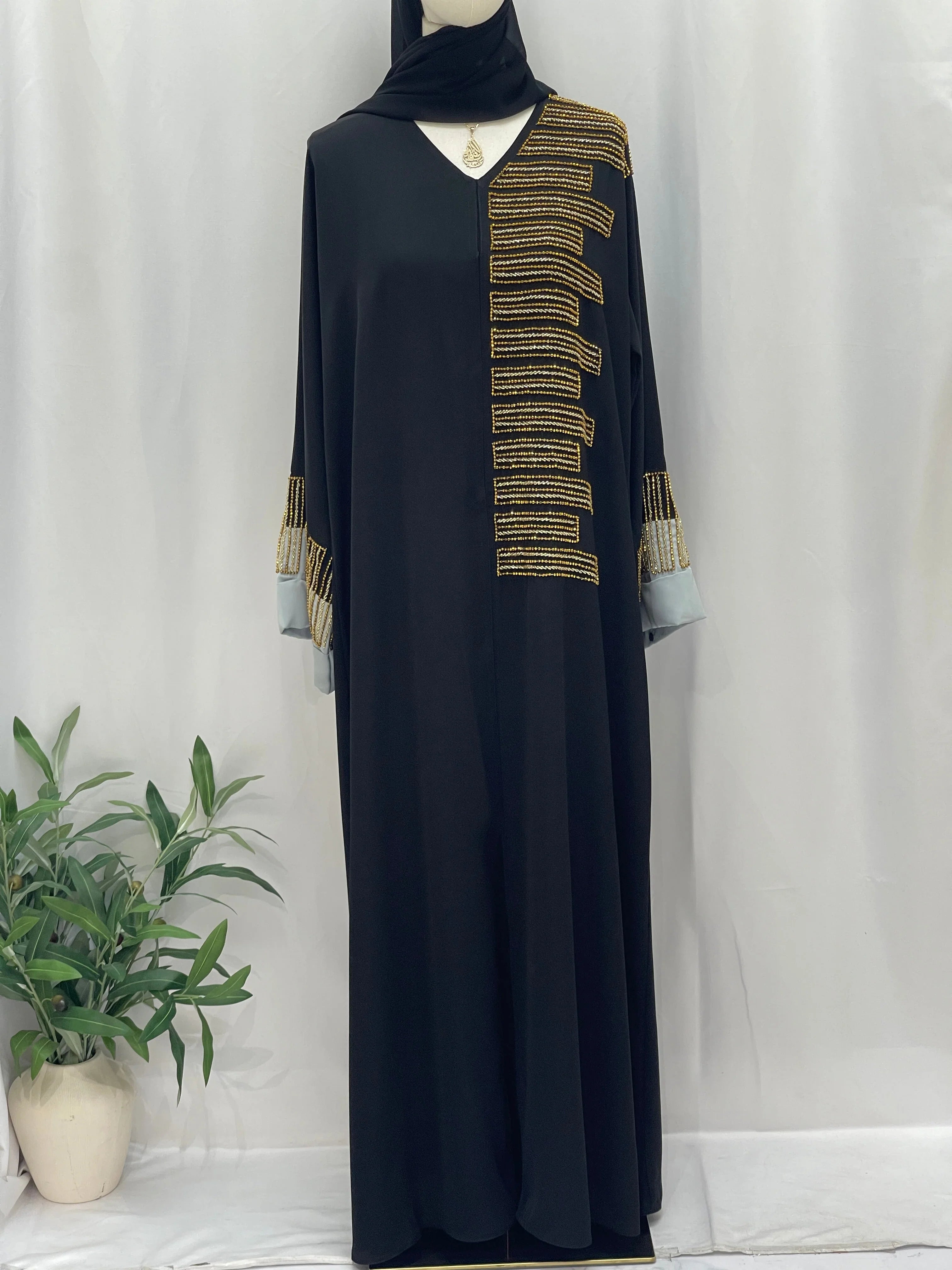 Palestinian Elegance black abaya with gold beaded shoulder and cuff detailing Fancy Beads Dubai Abaya