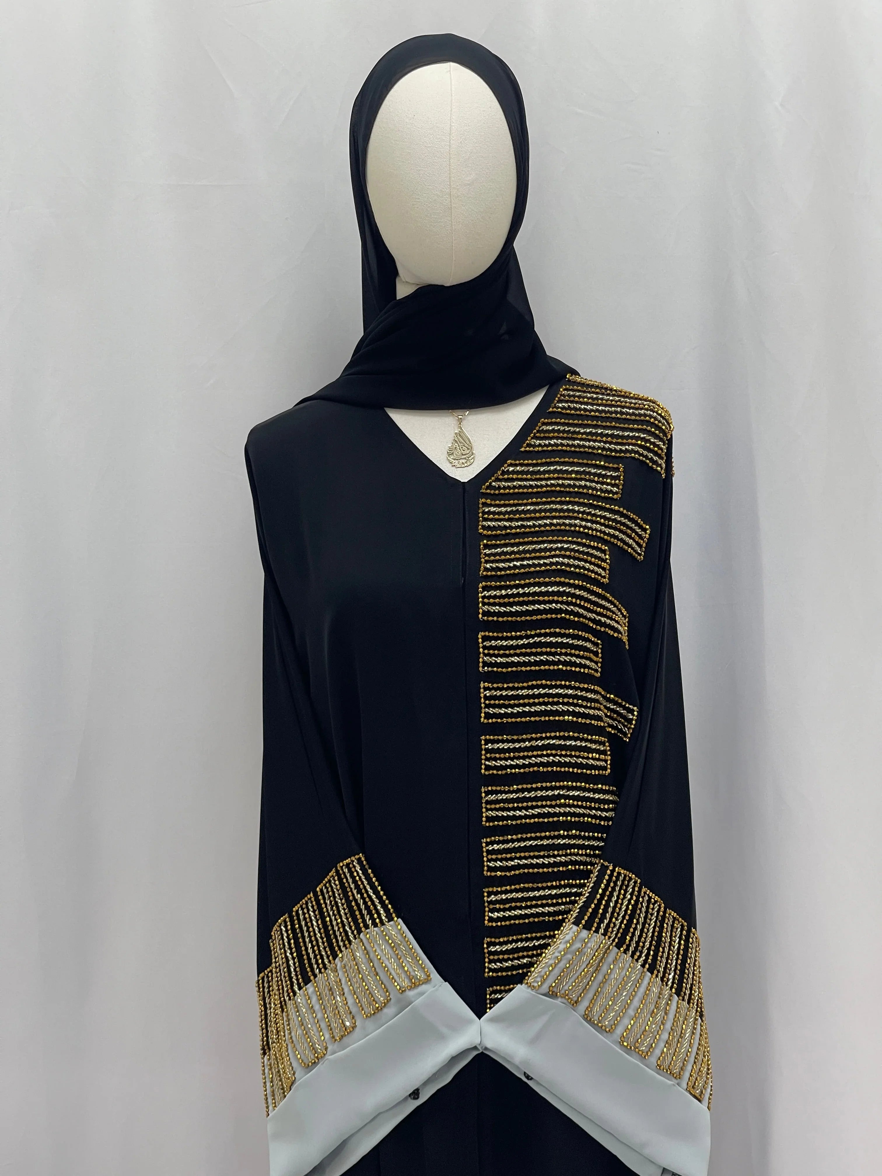 Palestinian Elegance Fancy Beads Dubai Abaya black abaya with gold bead panel and embellished gray cuff sleeves