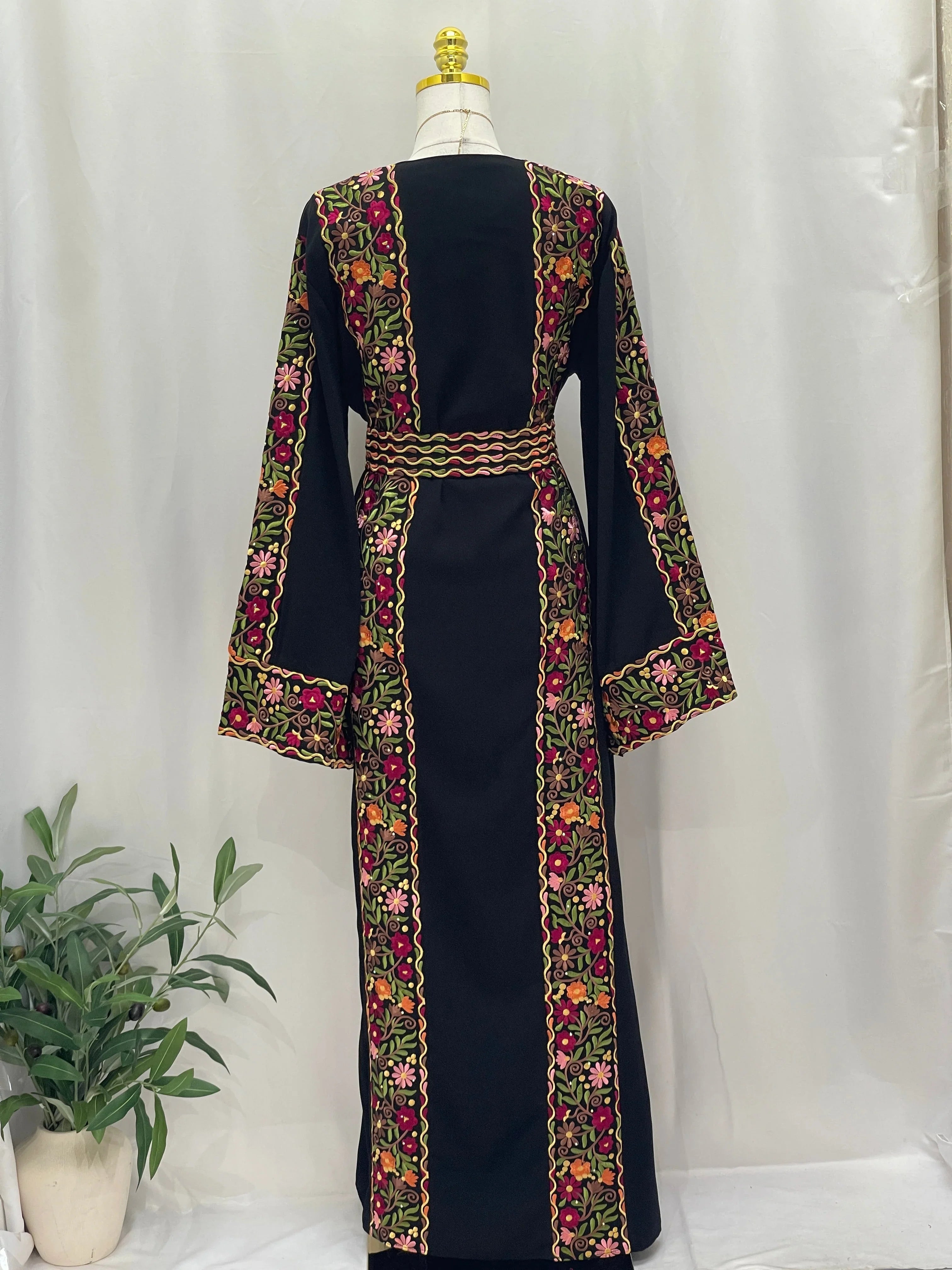 Back view of Floral Essence Embroidered Thobe featuring vibrant floral designs and traditional detailing